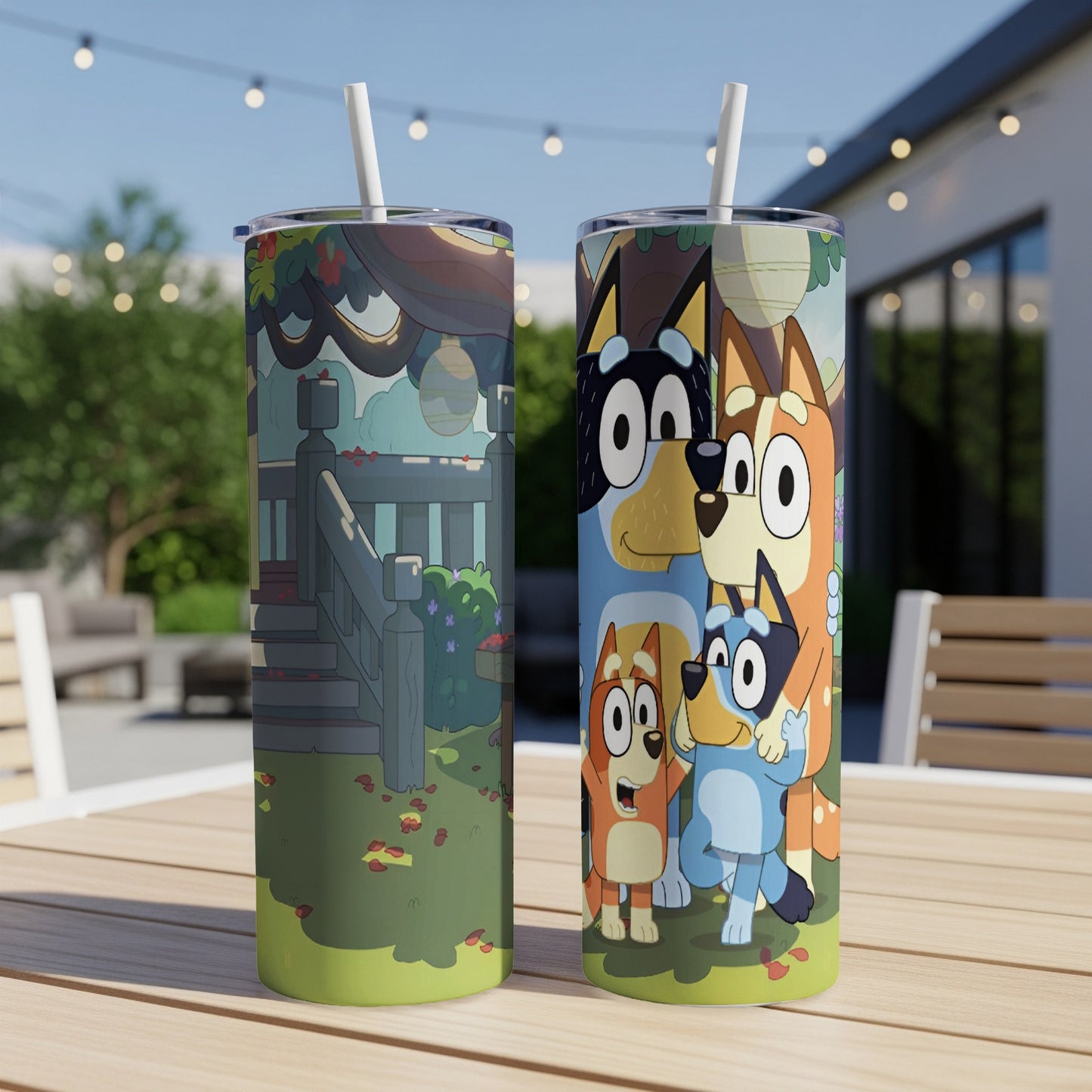 Bluey characters on a blue tumbler with straw, outdoors.