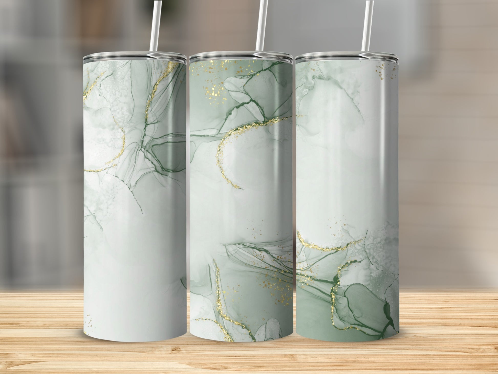 Three tall tumblers with green marble and gold accents.