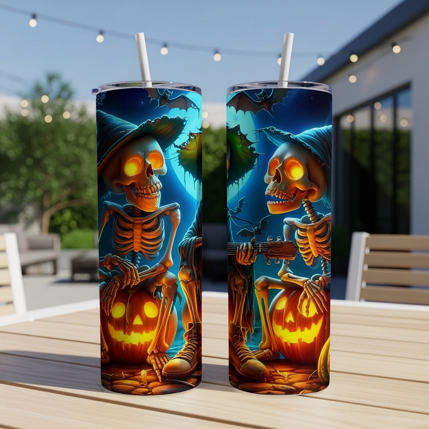Two Halloween tumblers with skeletons playing guitar and holding jack-o'-lanterns.