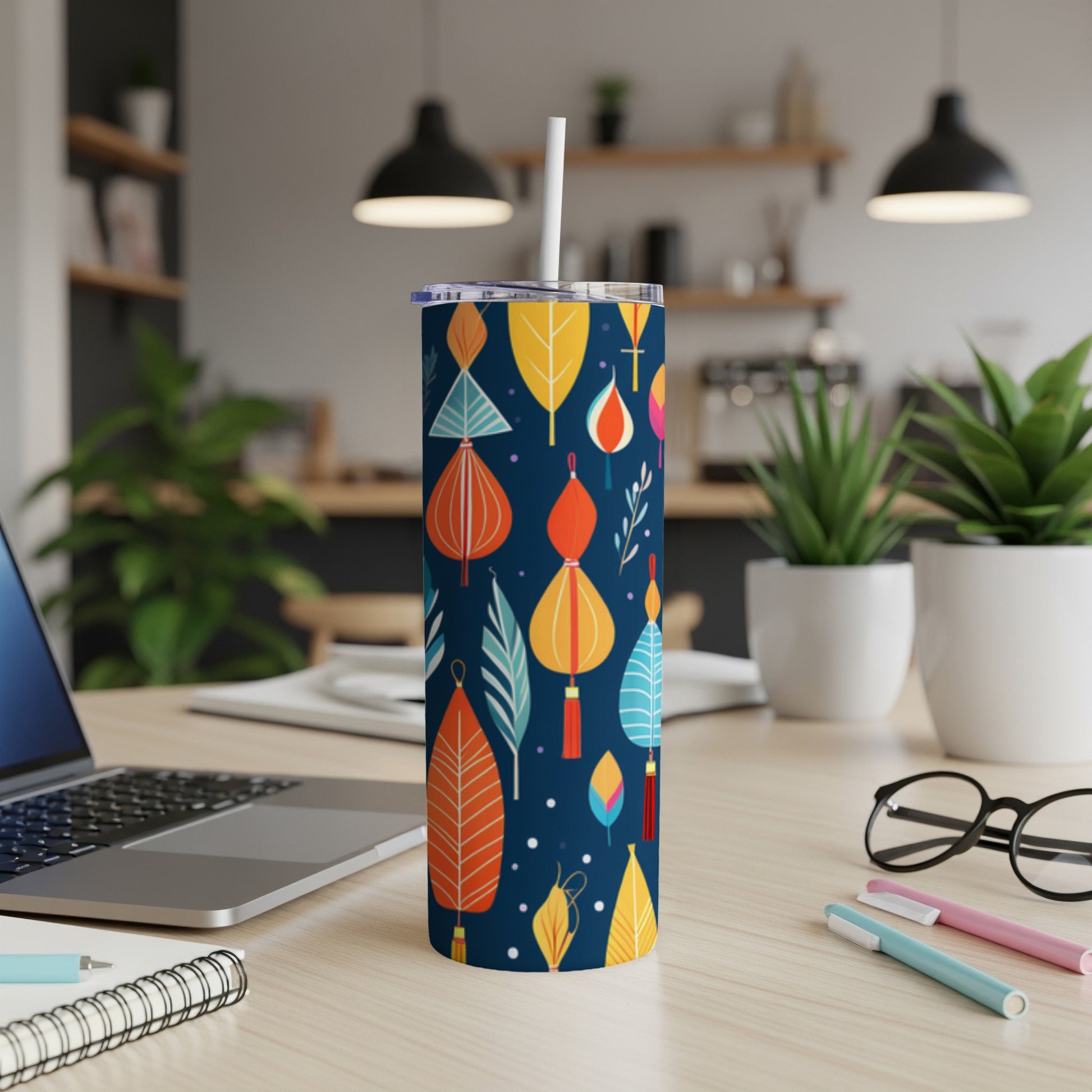 Dark blue tumbler with colorful lantern and leaf pattern, white straw.