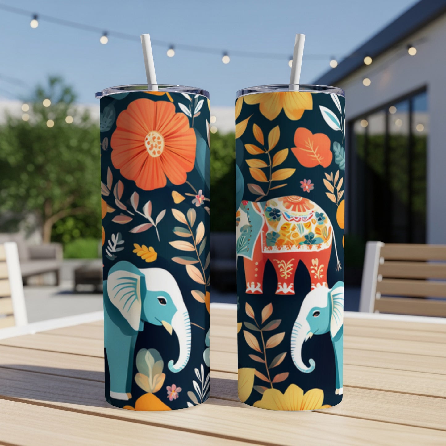 Two tumblers with a colorful elephant and floral pattern on a table.