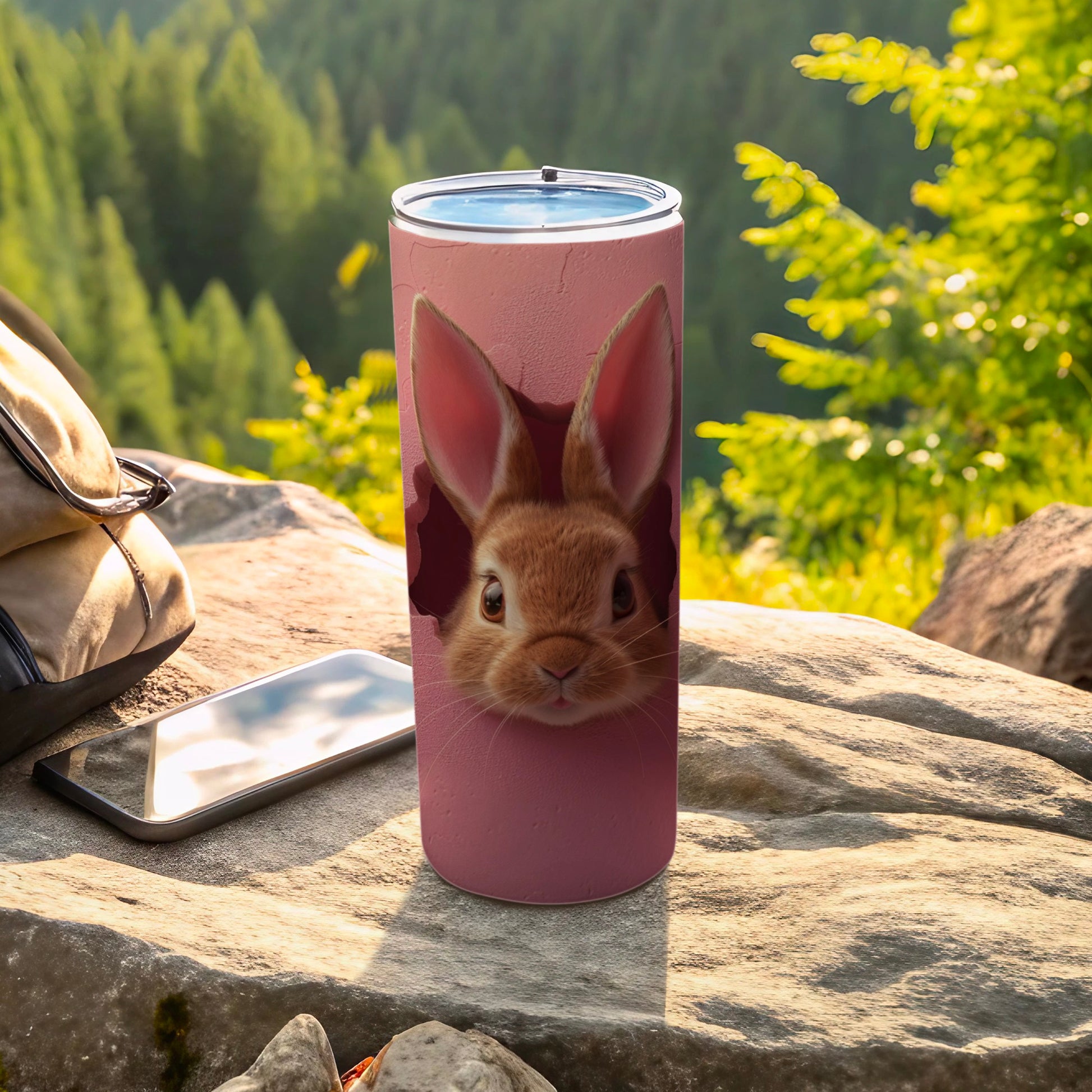 Pink tumbler with a cute bunny face peeking out of a hole.