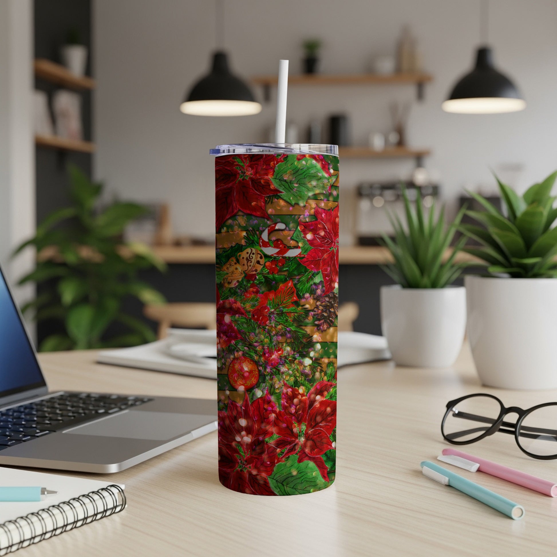Red poinsettia and glitter Christmas pattern on a stainless steel tumbler.