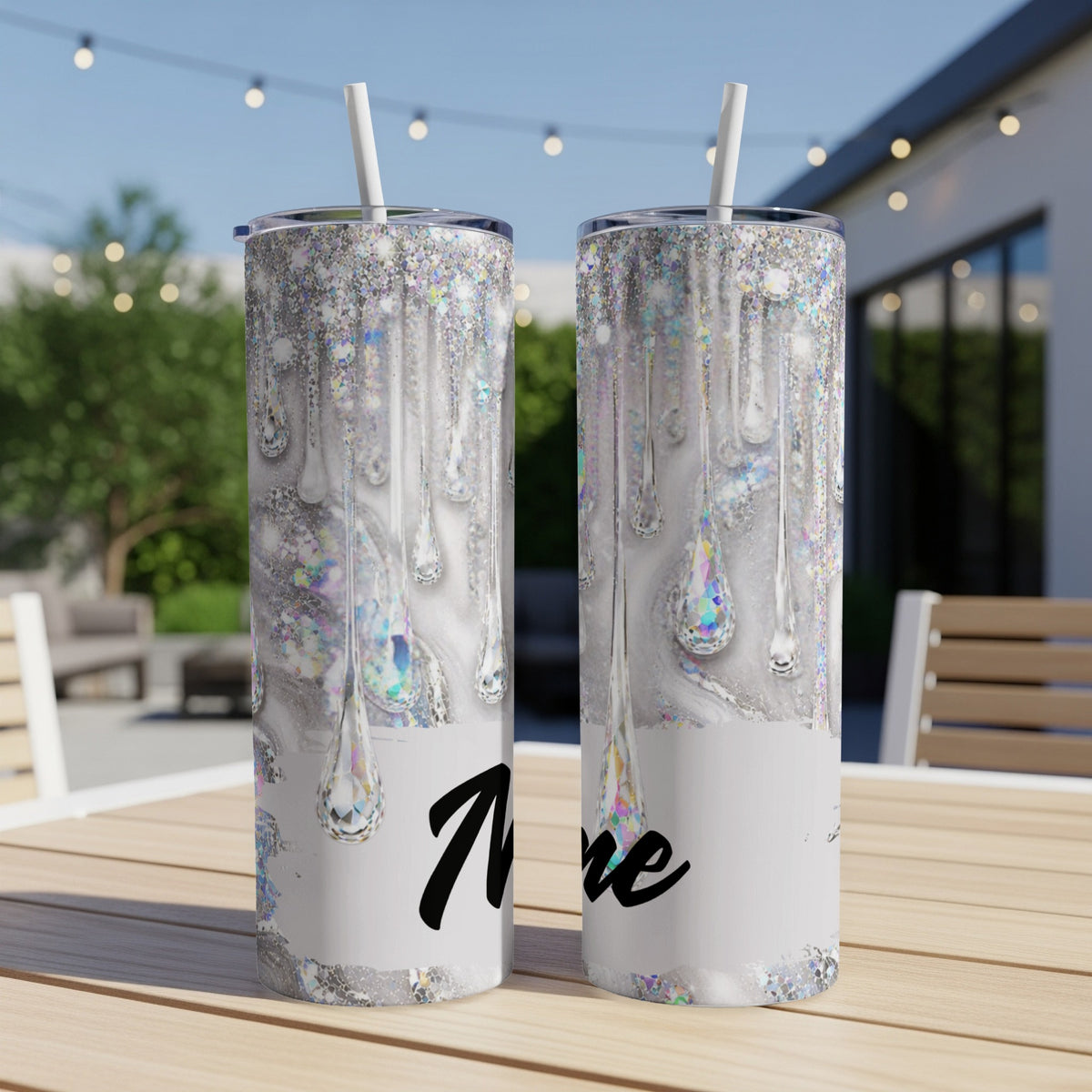 Two glitter drip tumblers with the name "Mire" printed on them.