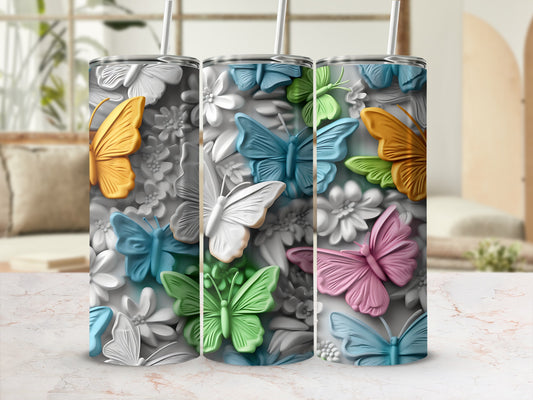 Tumbler with raised butterflies and flowers in yellow, blue, green, and pink.