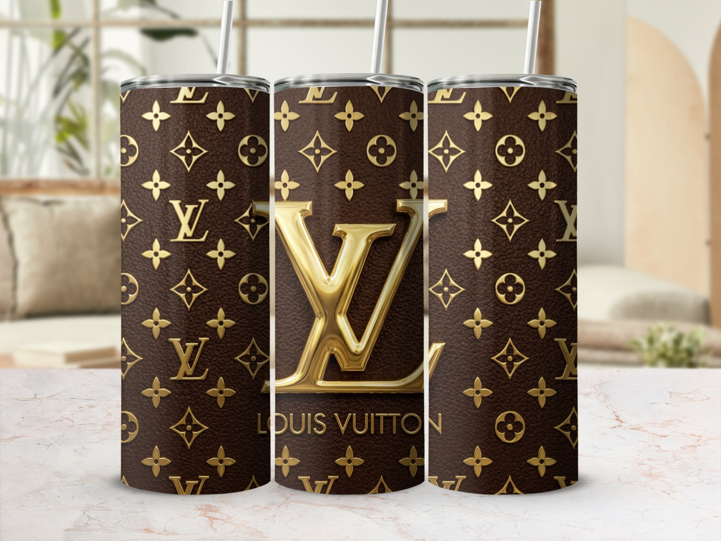 Three tumblers featuring a Louis Vuitton monogram pattern and gold LV logo.