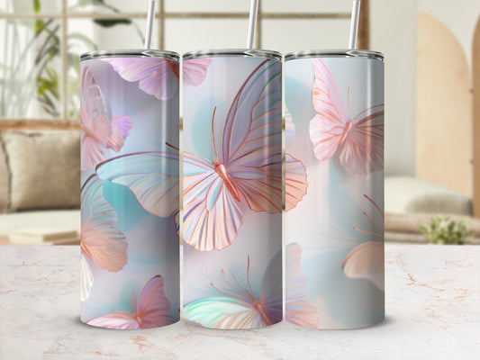 Three tumblers with pastel butterfly designs and straws.