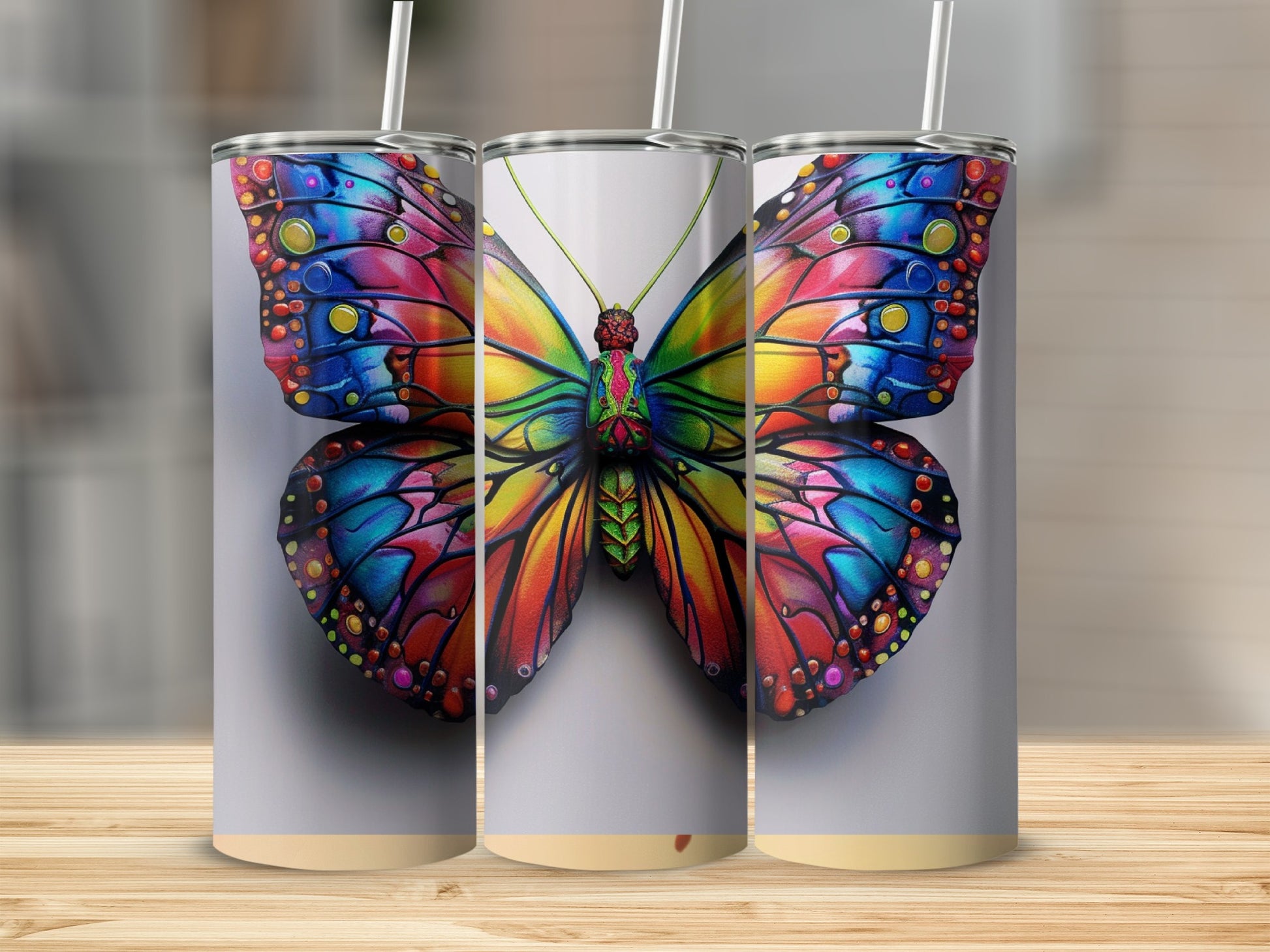Three tumblers featuring a colorful, stained-glass butterfly design.