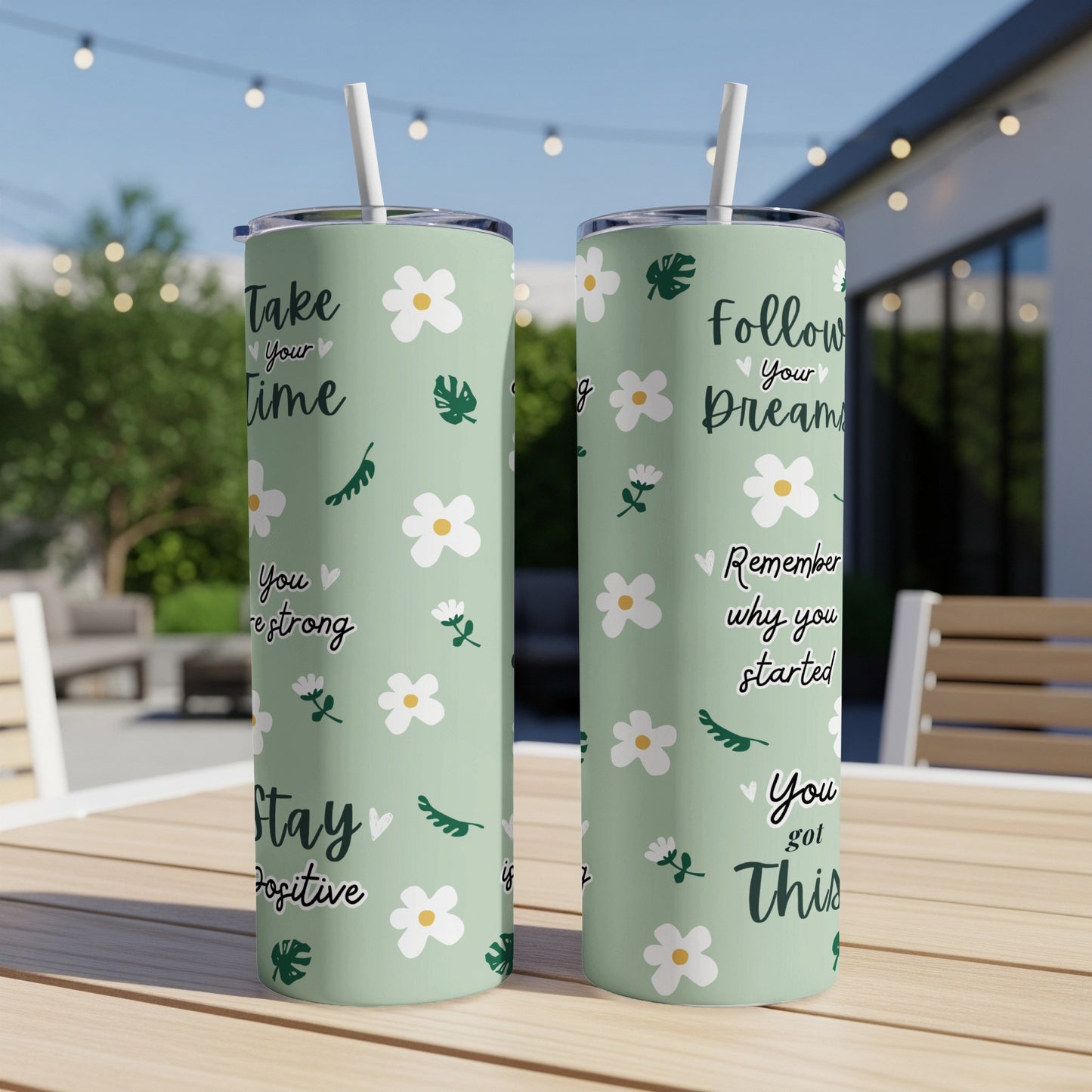 Green tumblers with floral pattern and motivational text.