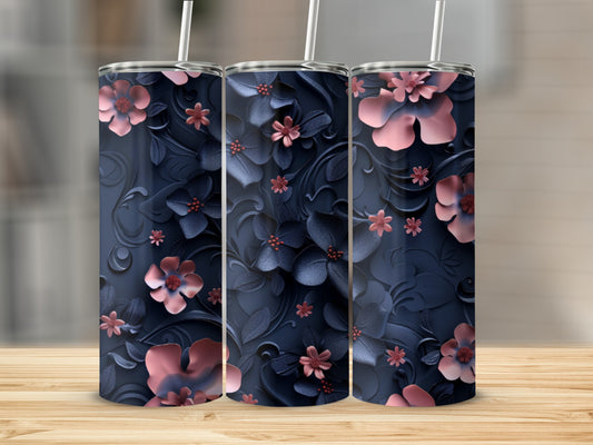Three navy tumblers with embossed pink and navy floral patterns and straws.
