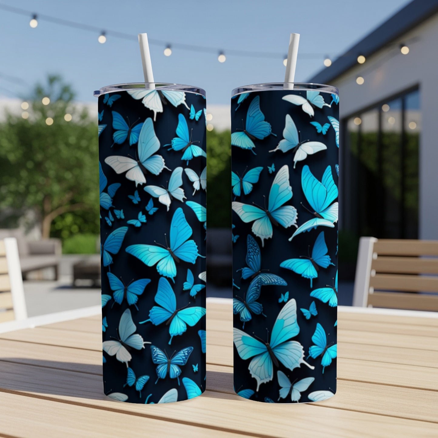 Two dark tumblers with a repeating pattern of blue butterflies.