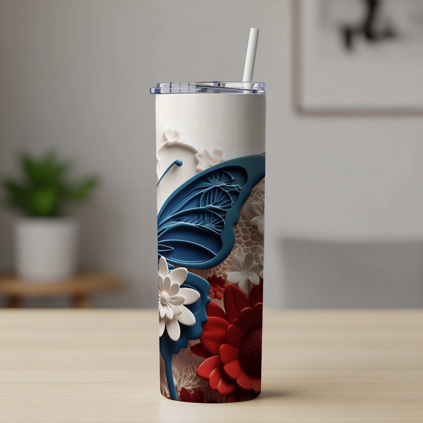 White tumbler with blue butterfly and red floral design.