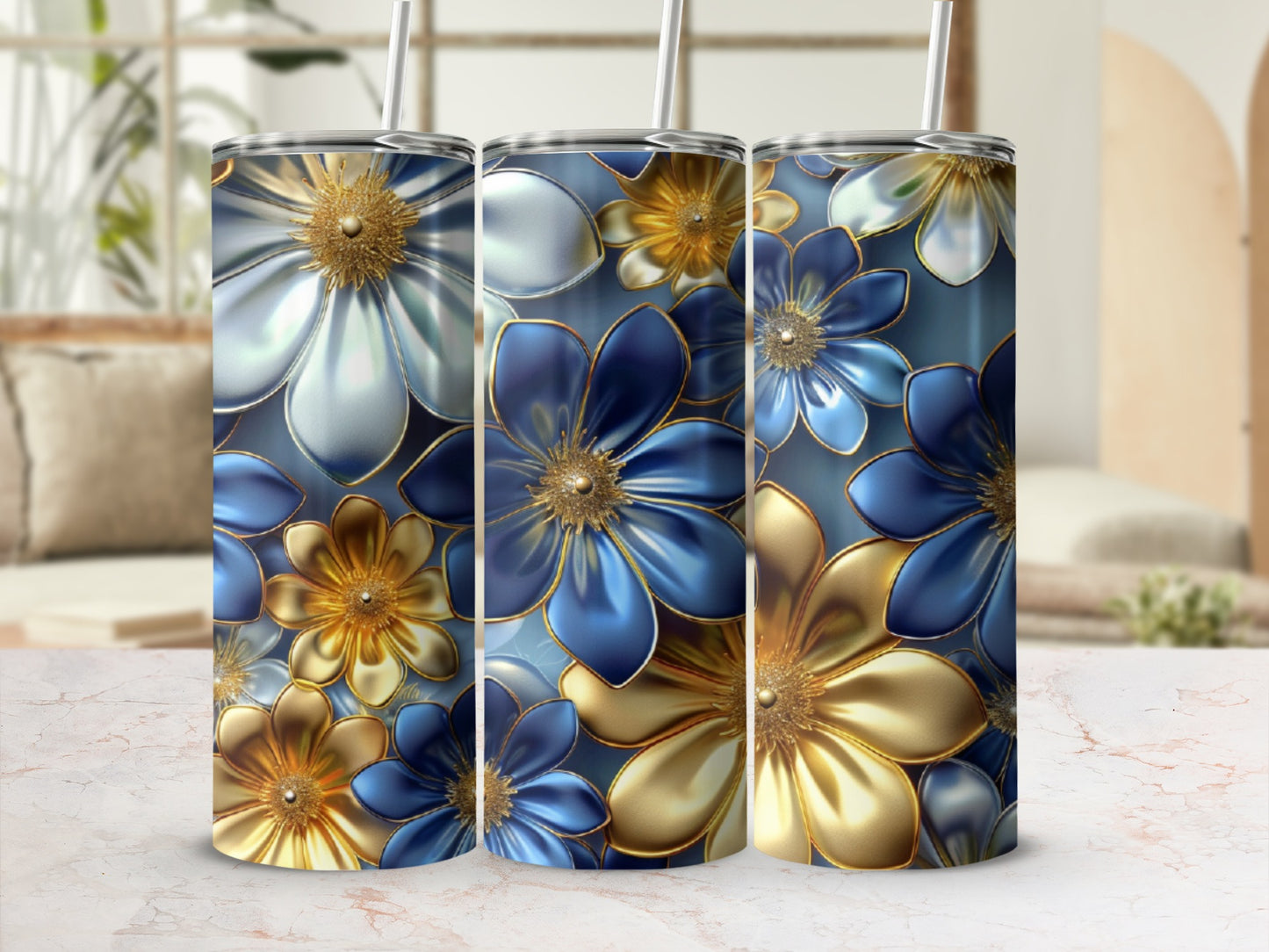 Three tumblers with blue and gold floral design on a light background.