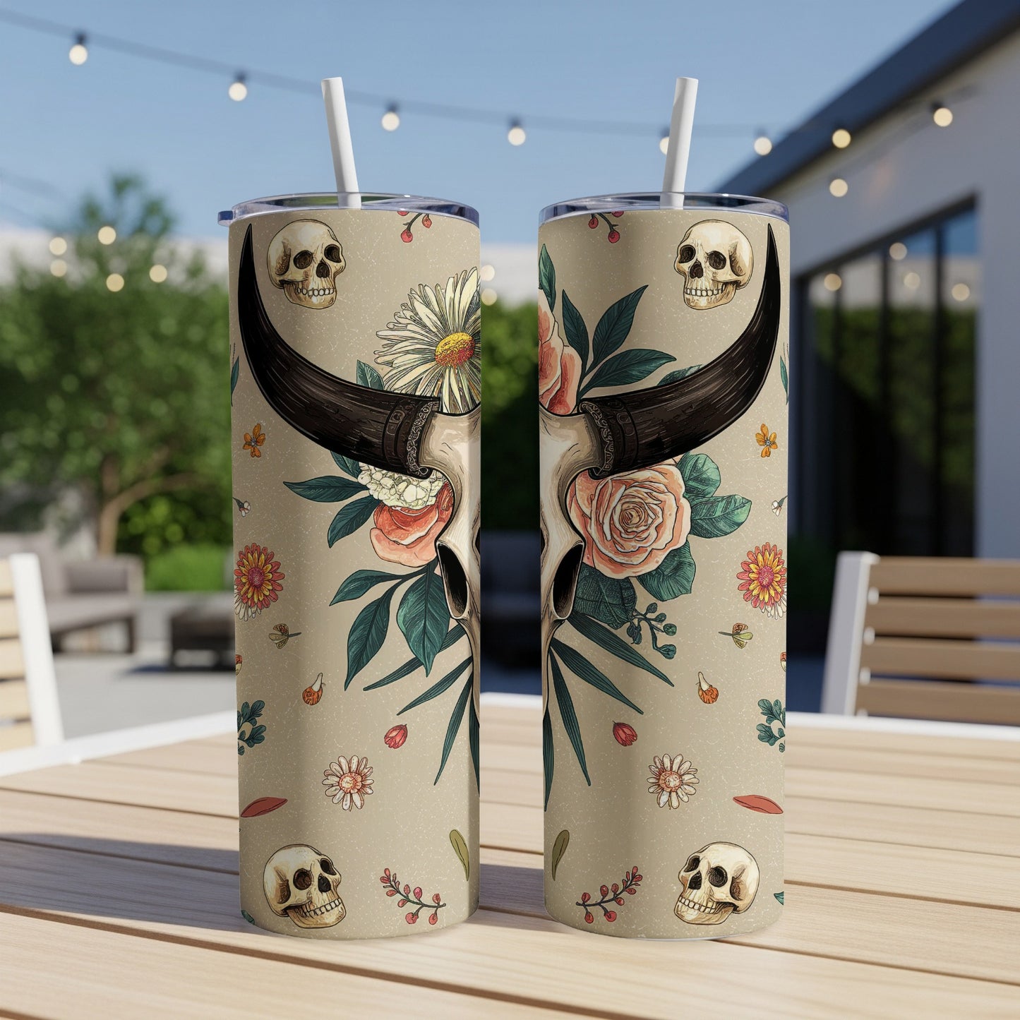 Floral skull tumbler with straw on a table.