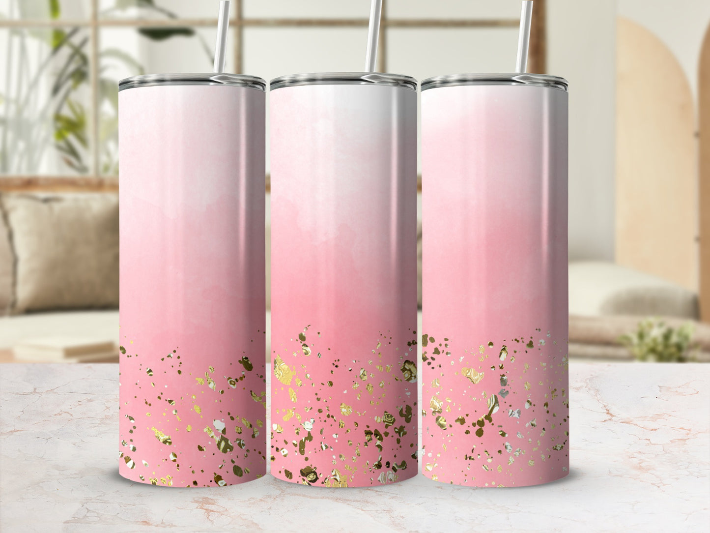 Three tumblers with pink gradient and gold glitter accents on a marble surface.