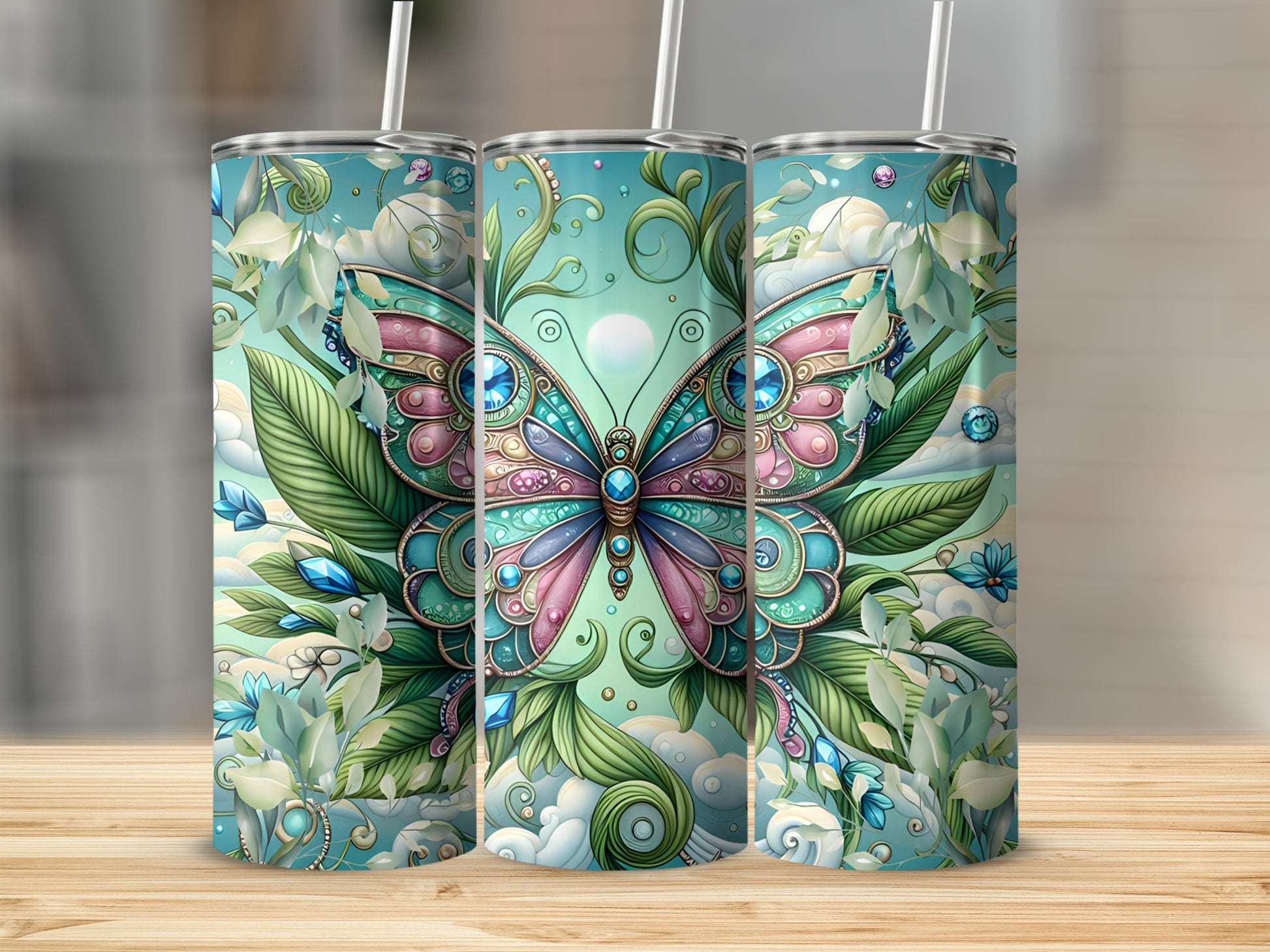 Three tumblers with a jeweled butterfly and foliage design.