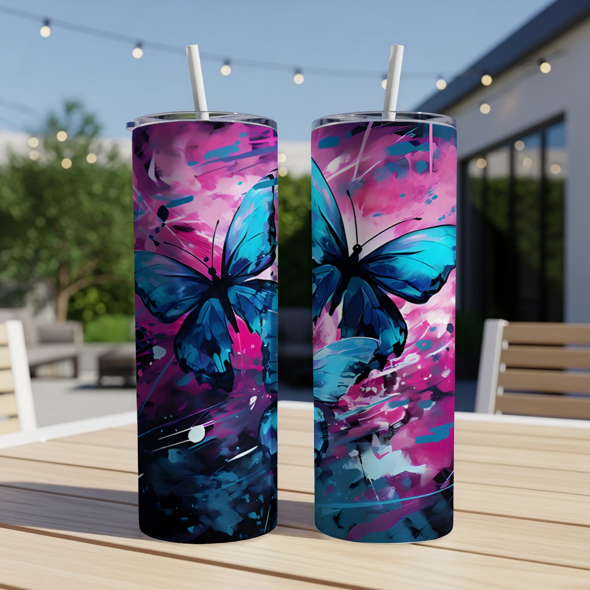 Two tumblers with blue butterflies and pink abstract paint splatters.