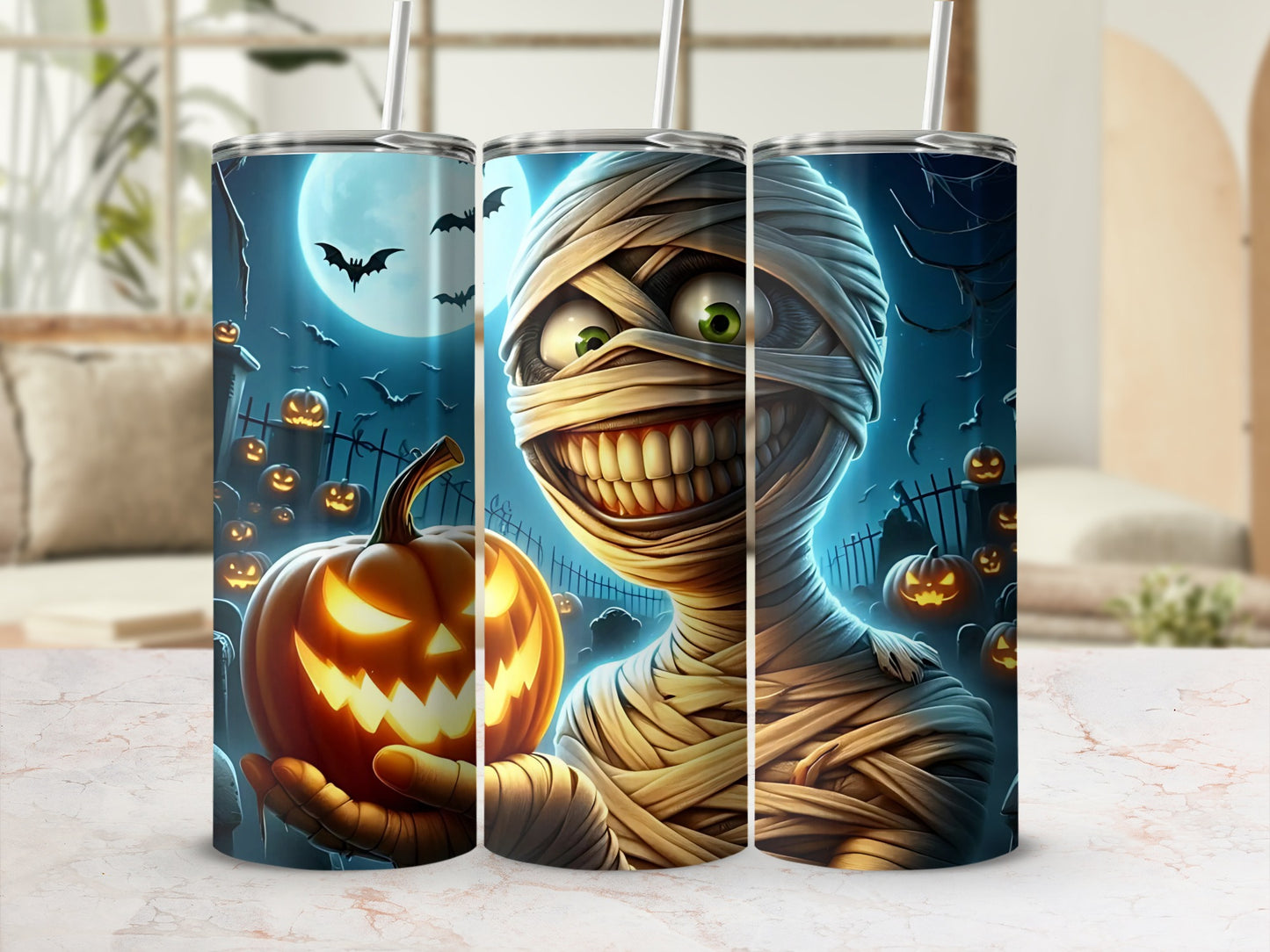 Three tumblers with Halloween designs: mummy, jack-o'-lantern, and bats.
