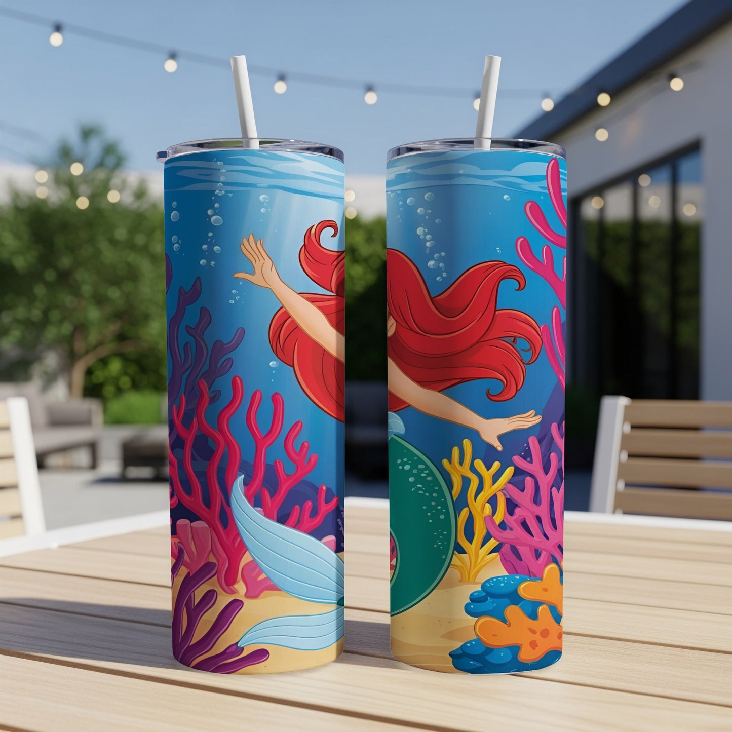 Two tumblers with The Little Mermaid characters and coral reef art.
