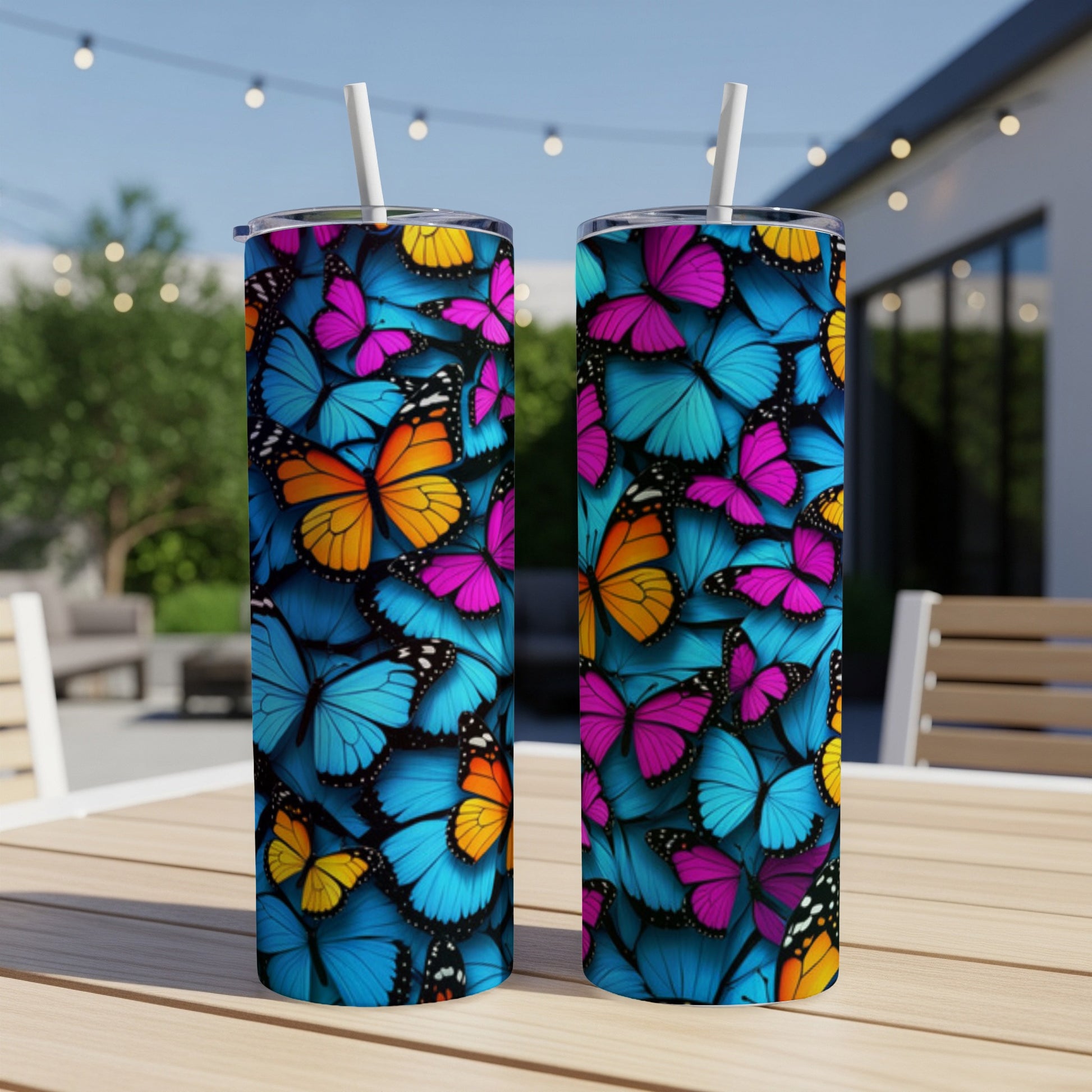 Two tall tumblers covered in a vibrant butterfly pattern.