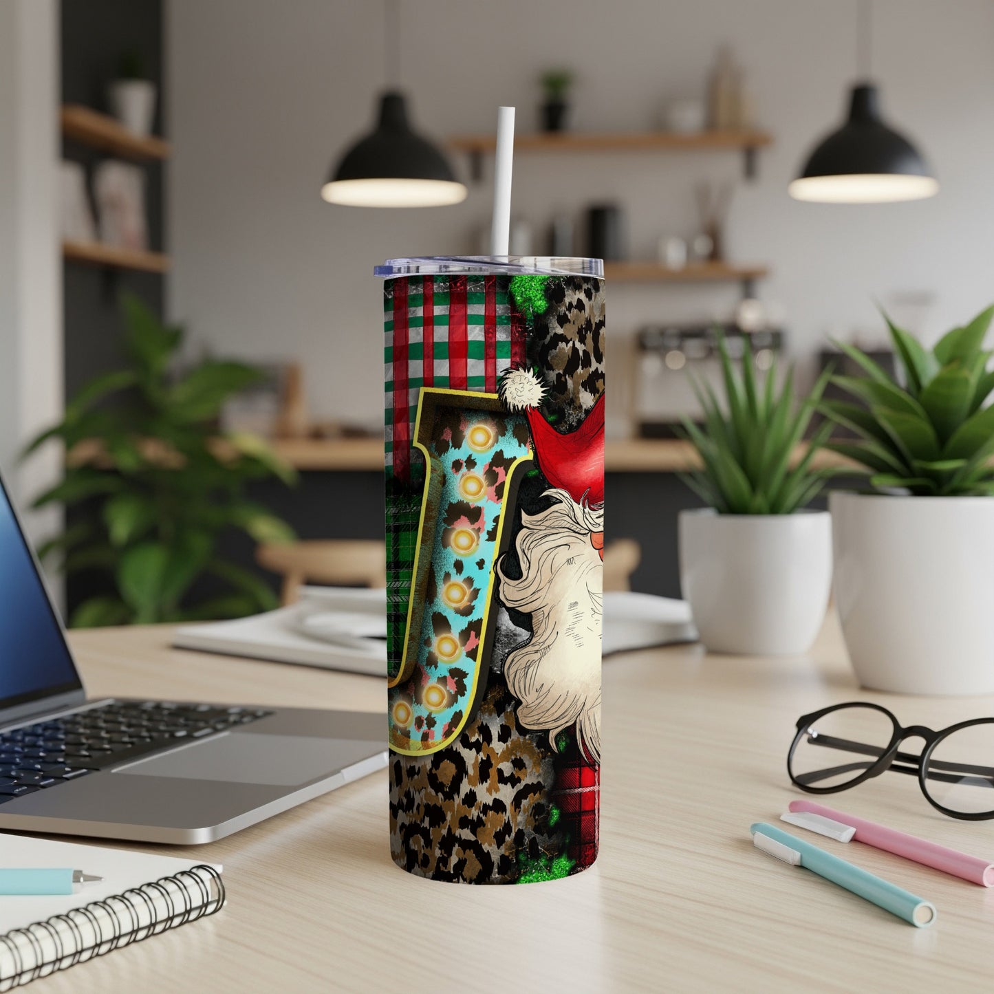 Santa Claus and festive pattern on a tumbler with a straw.