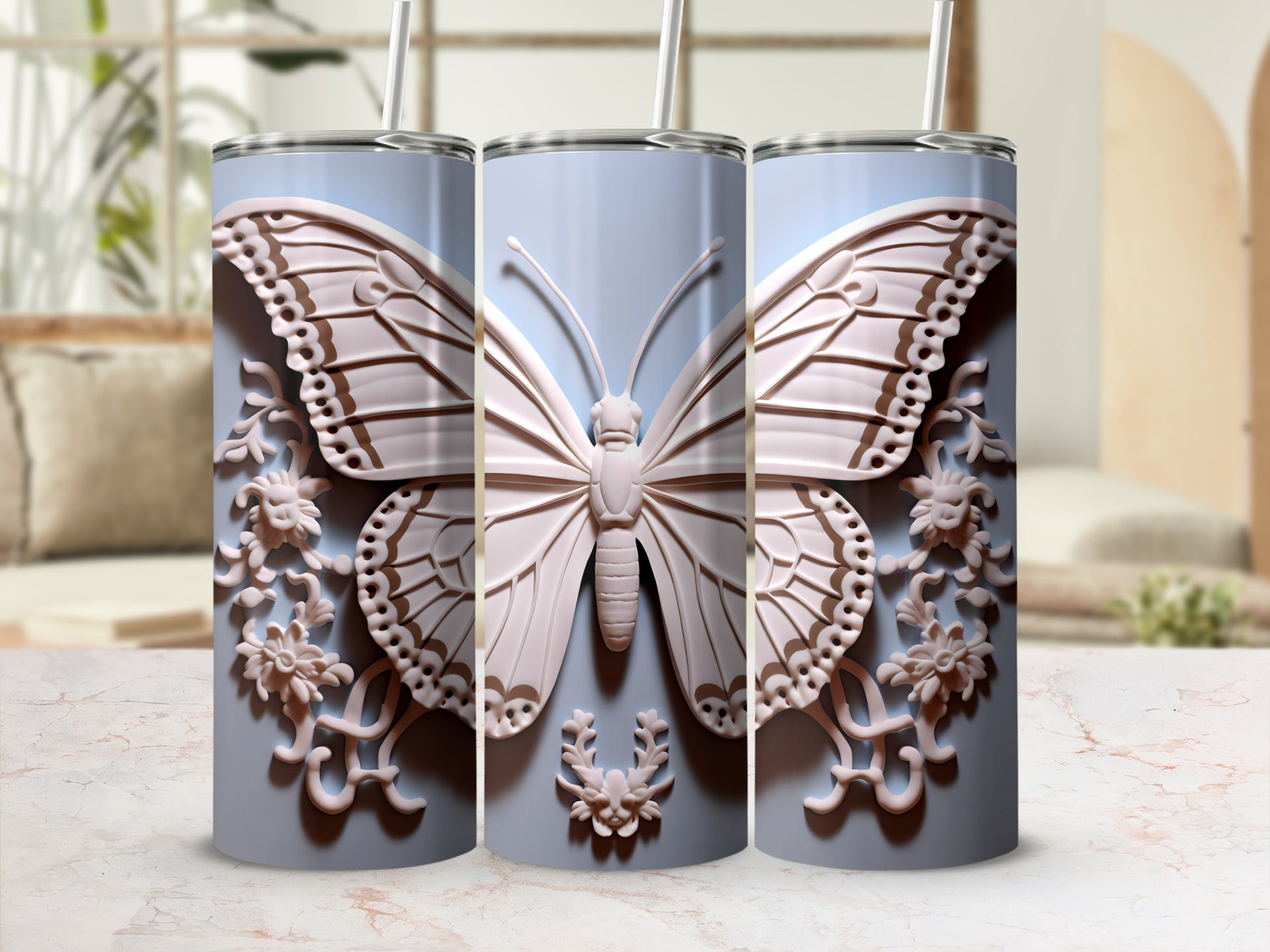 Three light blue tumblers with embossed butterflies and floral designs.