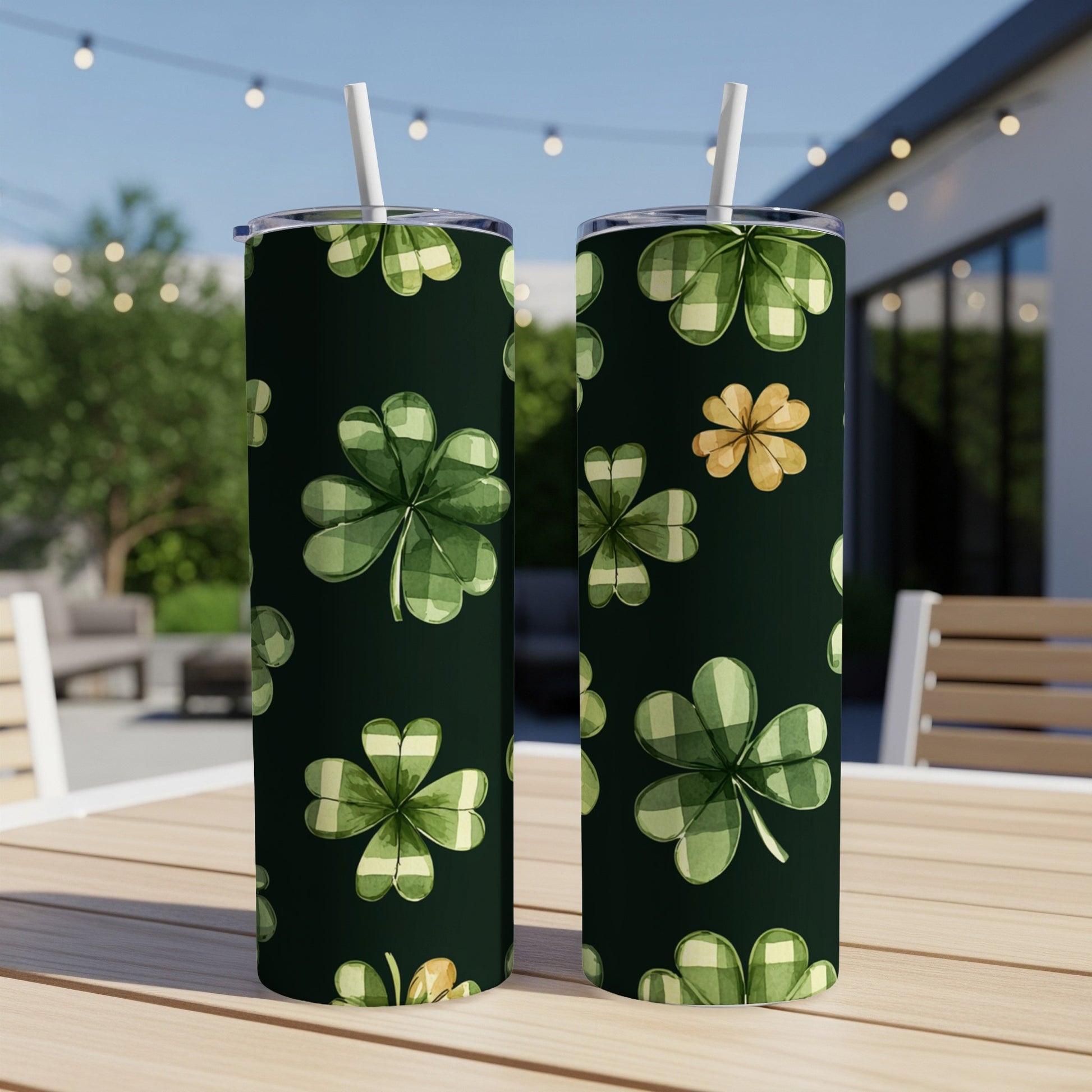 Green tumblers with shamrocks and plaid patterns on a table.