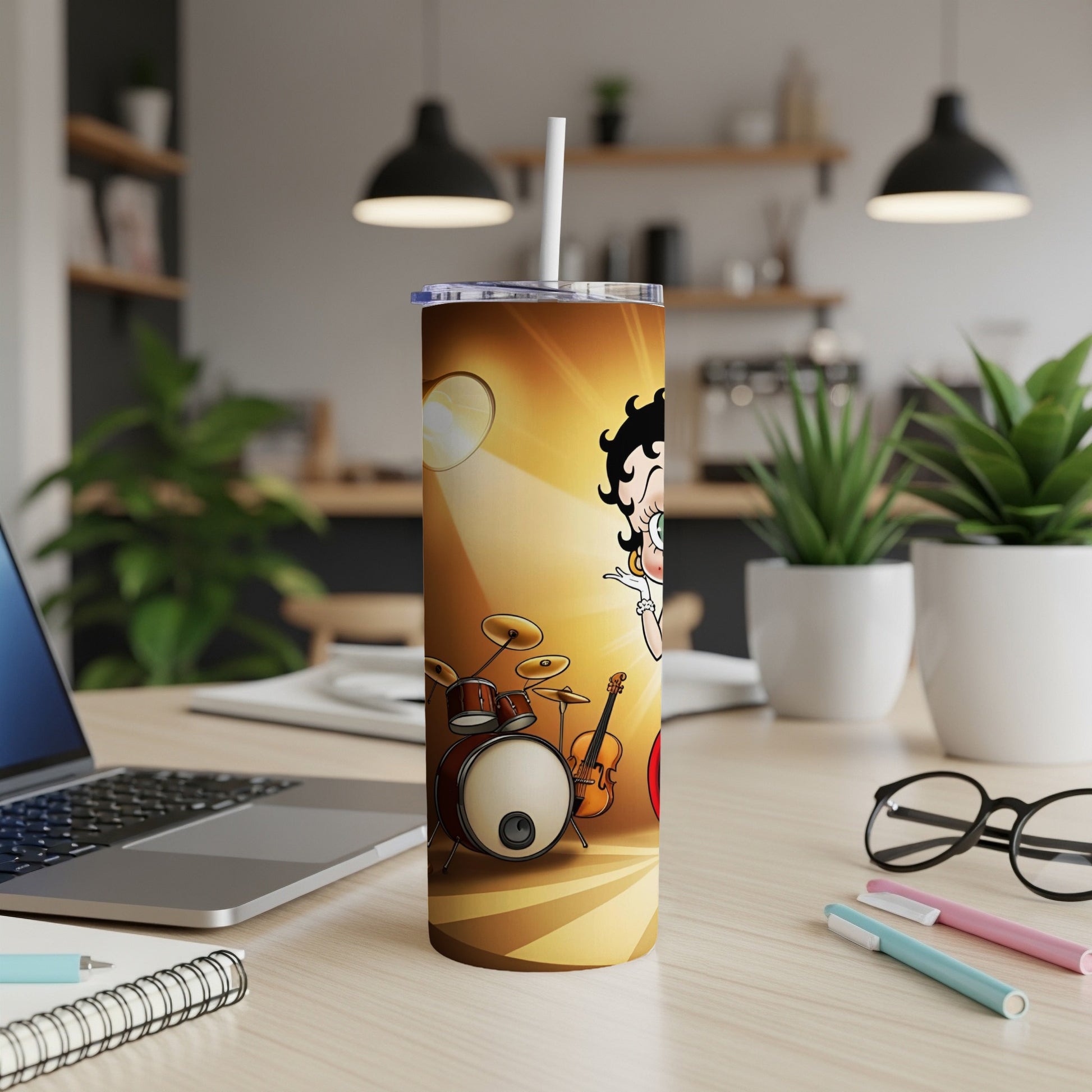 Betty Boop graphic on a gold and brown patterned tumbler with a drum and guitar.