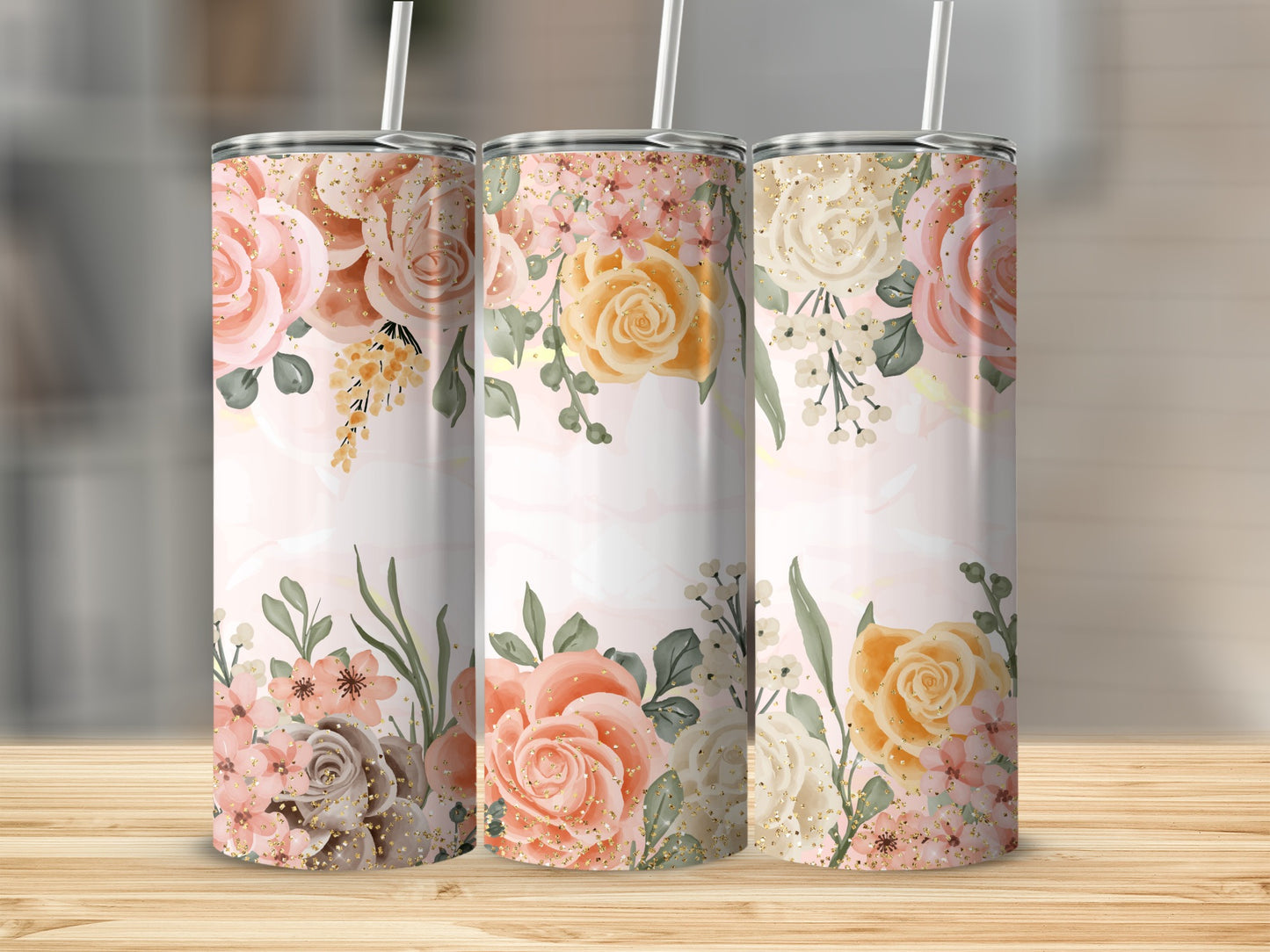 Three tumblers with a floral pattern of pink and yellow roses and greenery.
