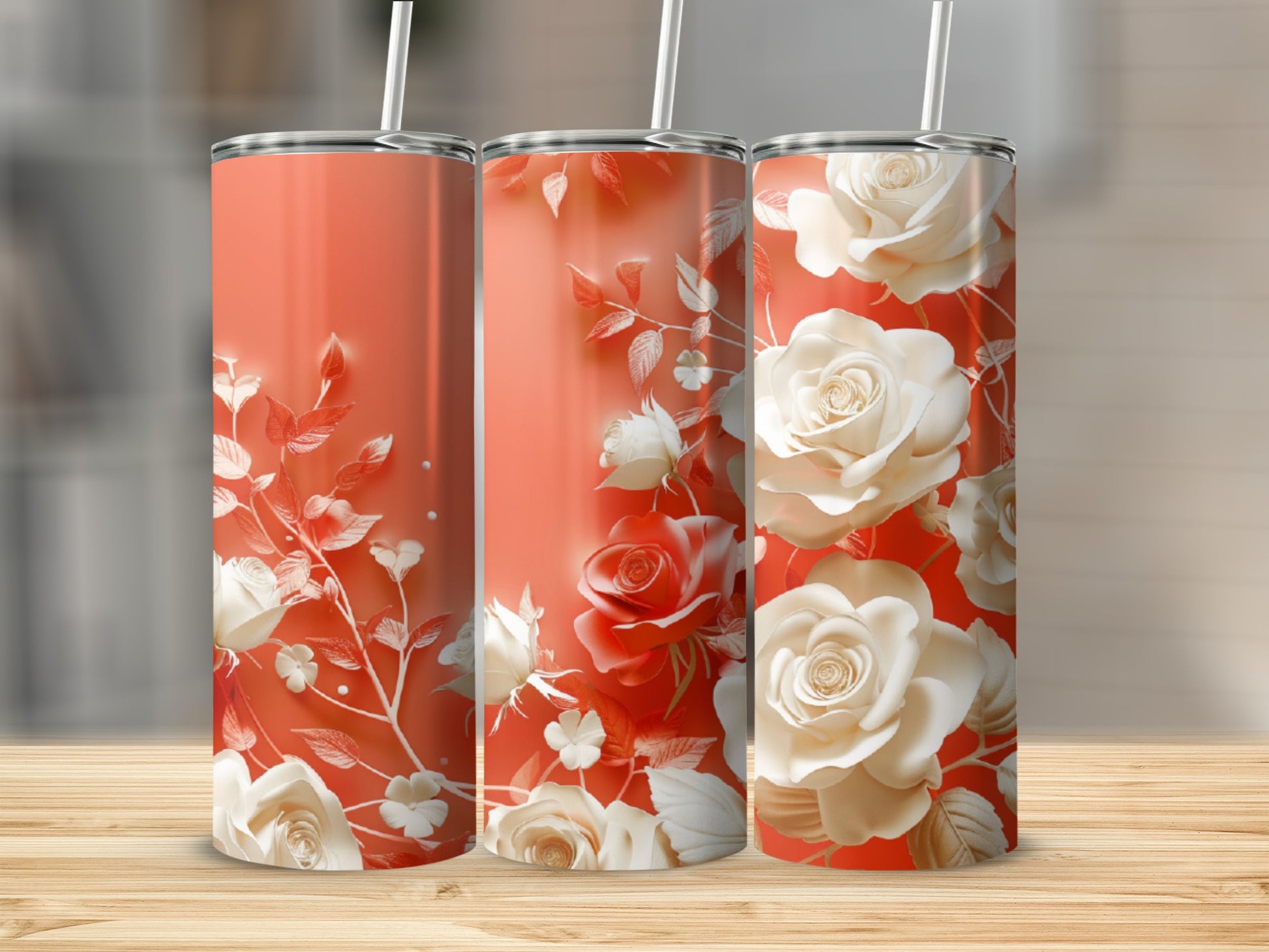Three coral tumblers with white rose and leaf floral designs.