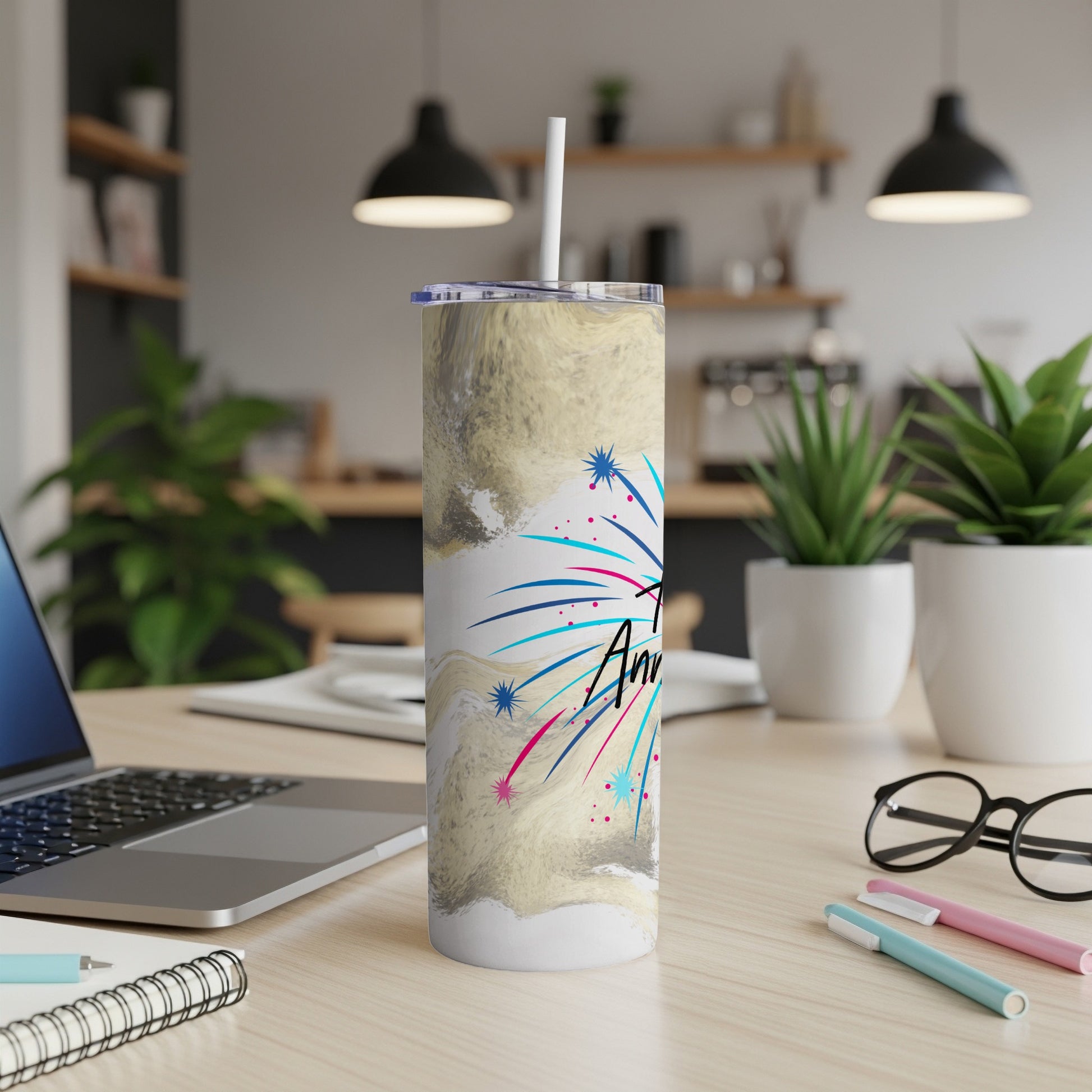 Tumbler with "America" text and fireworks design on a desk.
