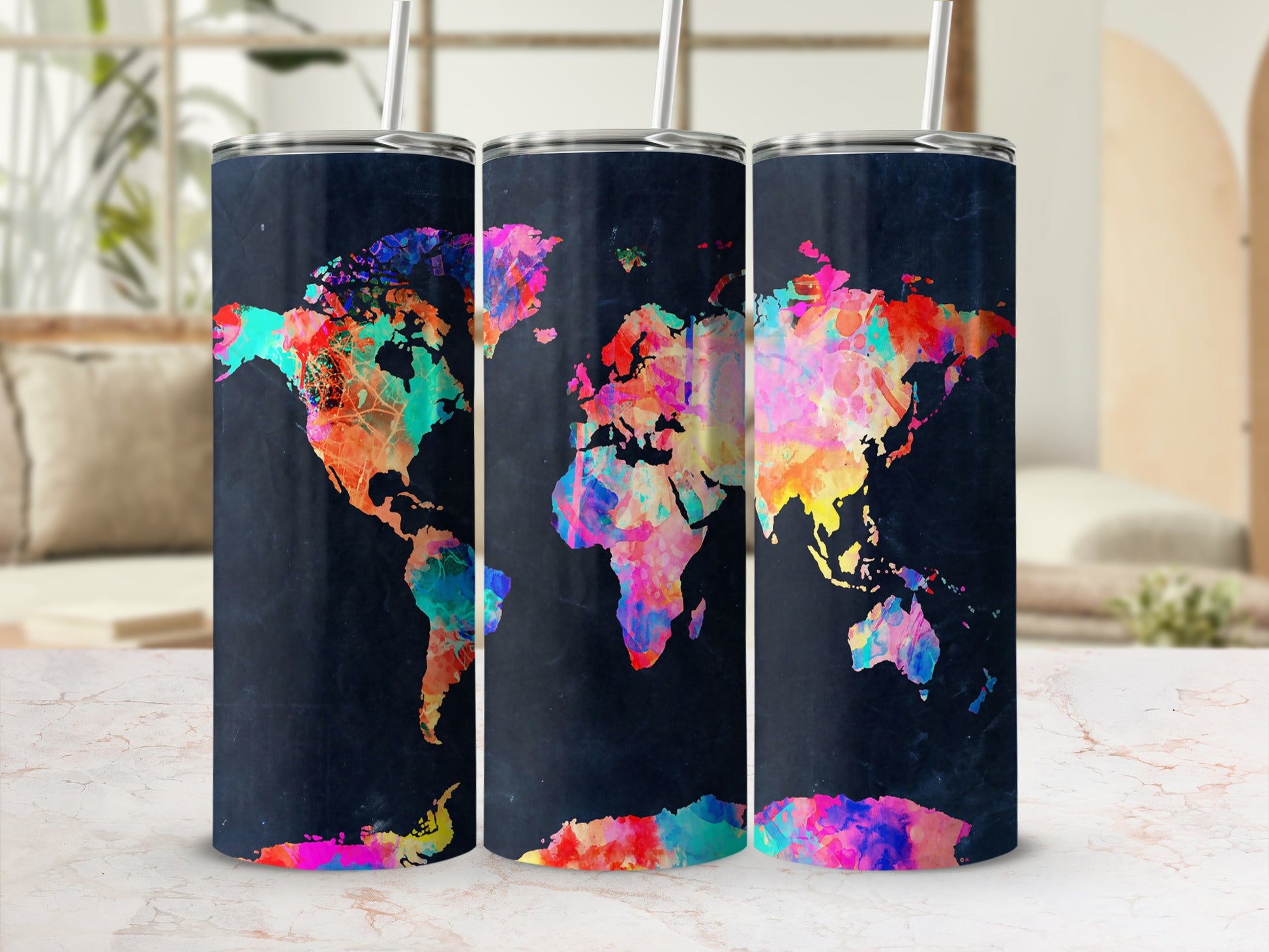 Three tumblers with a colorful watercolor world map design on a dark background.