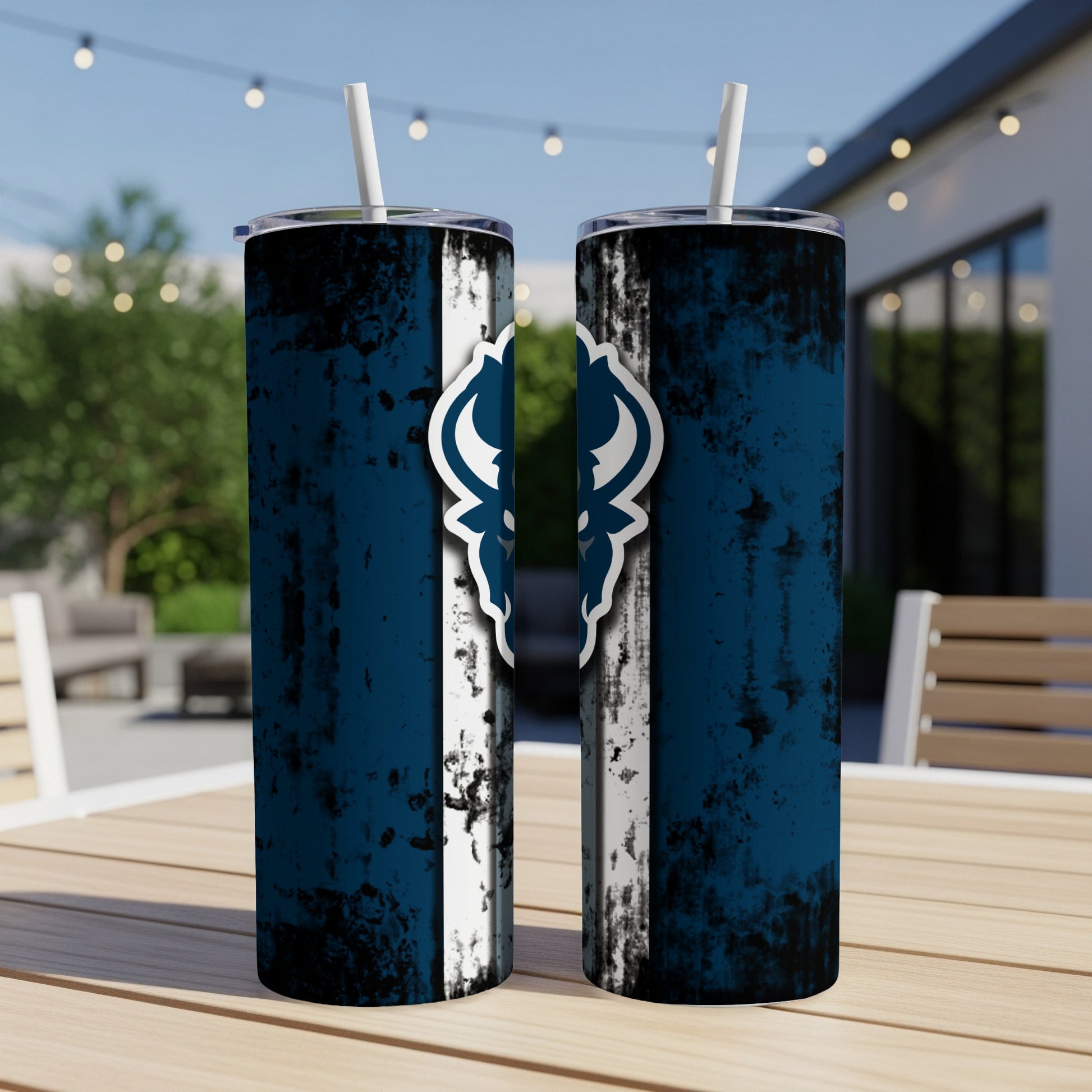 Two blue tumblers with white straws and a distressed white stripe with a dark blue emblem.