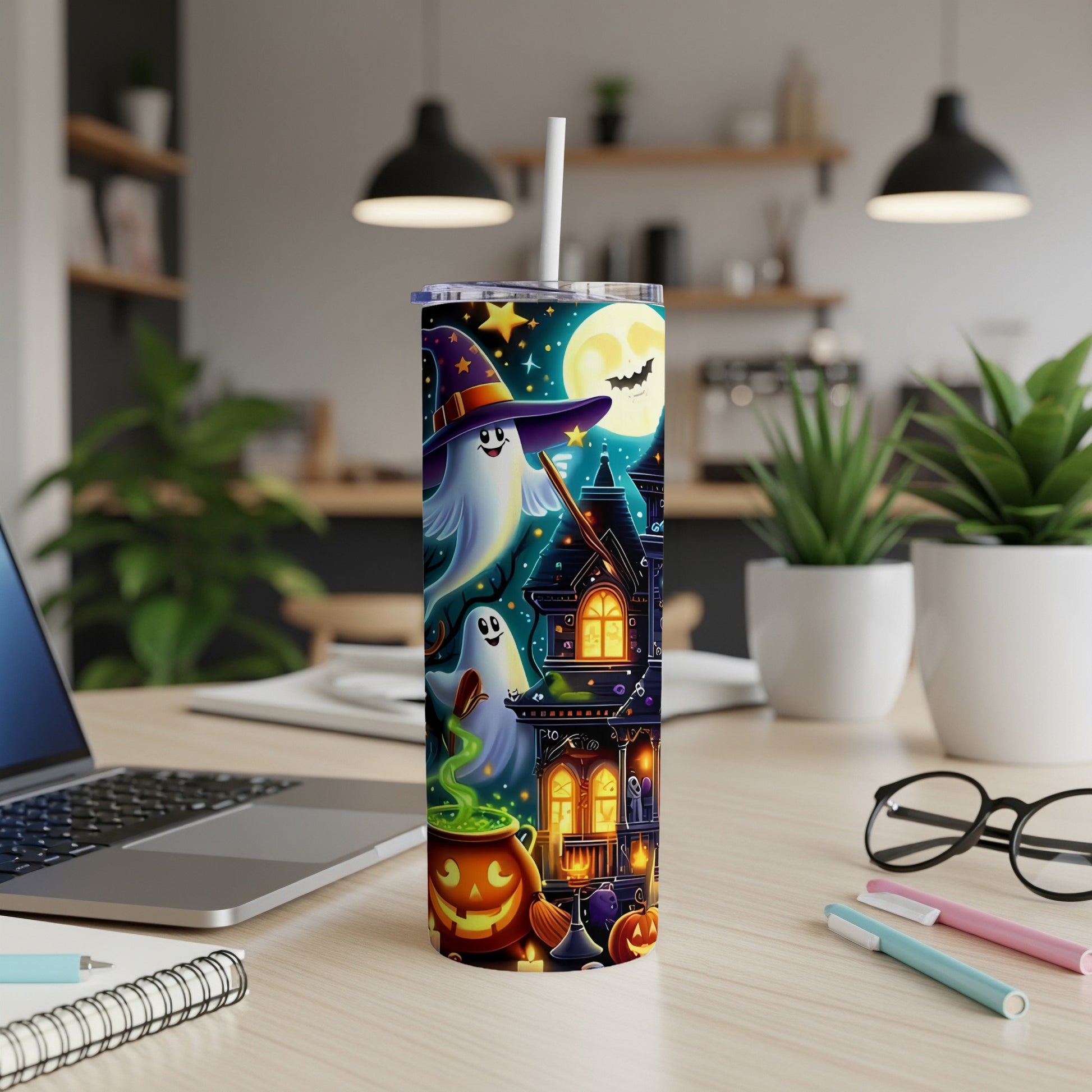 Tall tumbler with Halloween theme: ghosts, haunted house, moon, and pumpkins.