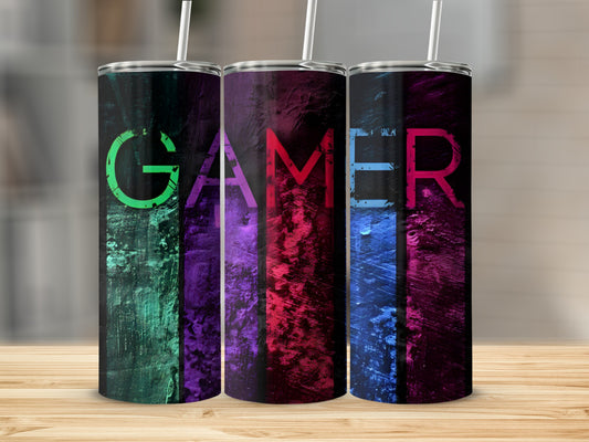 Three tumblers with "GAMER" text in neon colors against a distressed background.