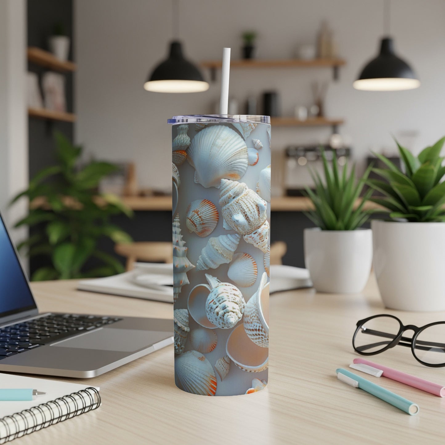 Seashell pattern on a tall, slender insulated tumbler with straw.