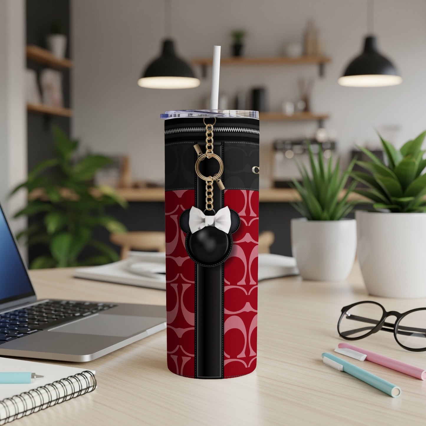Tumbler with red and black pattern, zipper detail, and Mickey Mouse charm keyring.