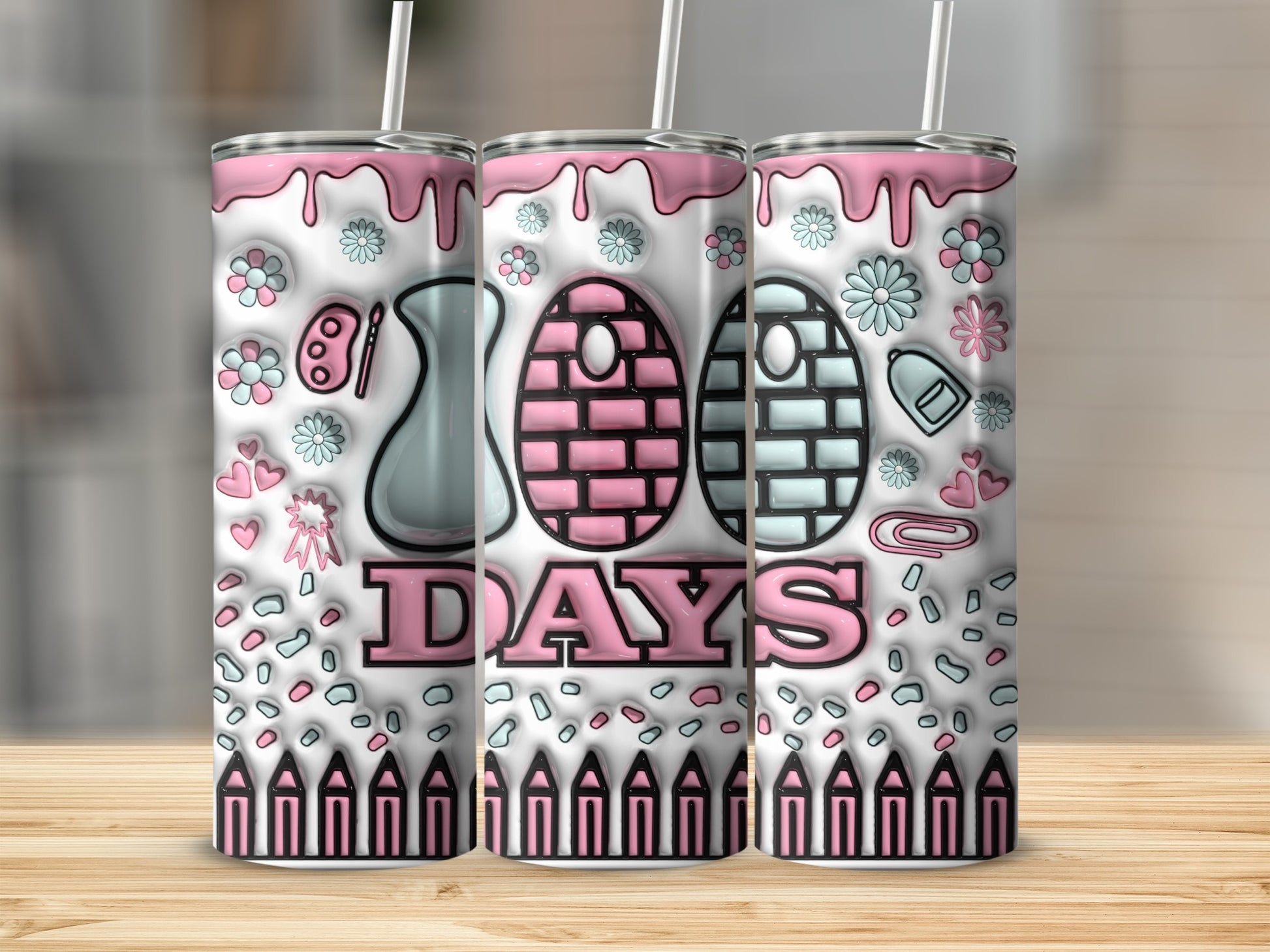 Pink and white 100 Days design on three tumblers with school-themed decorations.