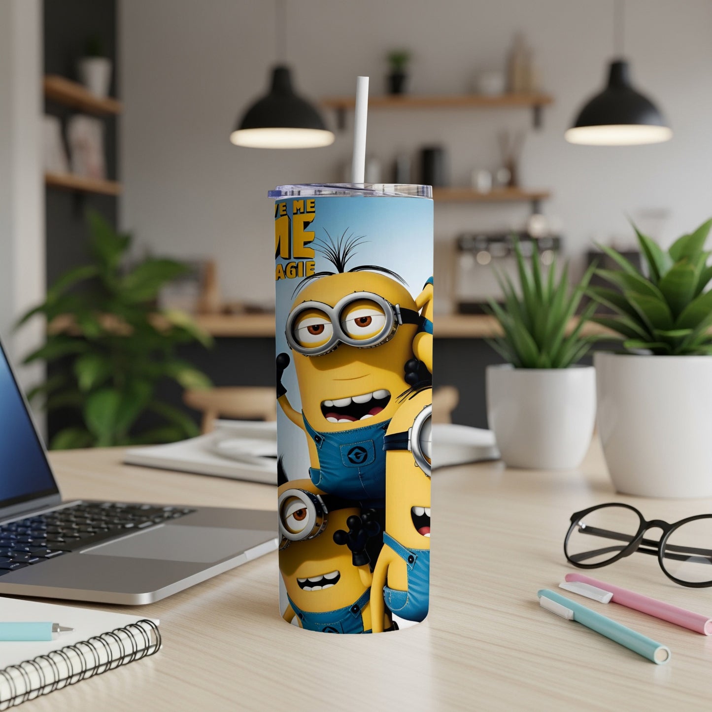 Three Minions characters with a straw in a tall blue tumbler.