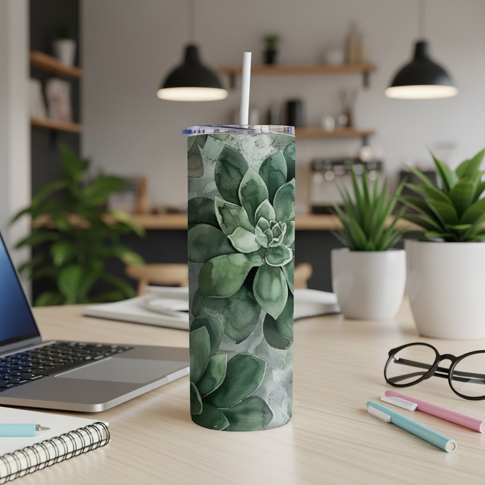 Green succulent plant pattern on a white stainless steel tumbler.