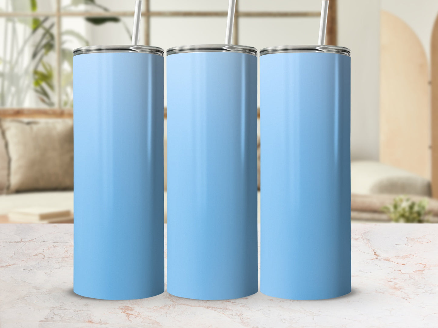 Three light blue stainless steel tumblers with straws side by side.