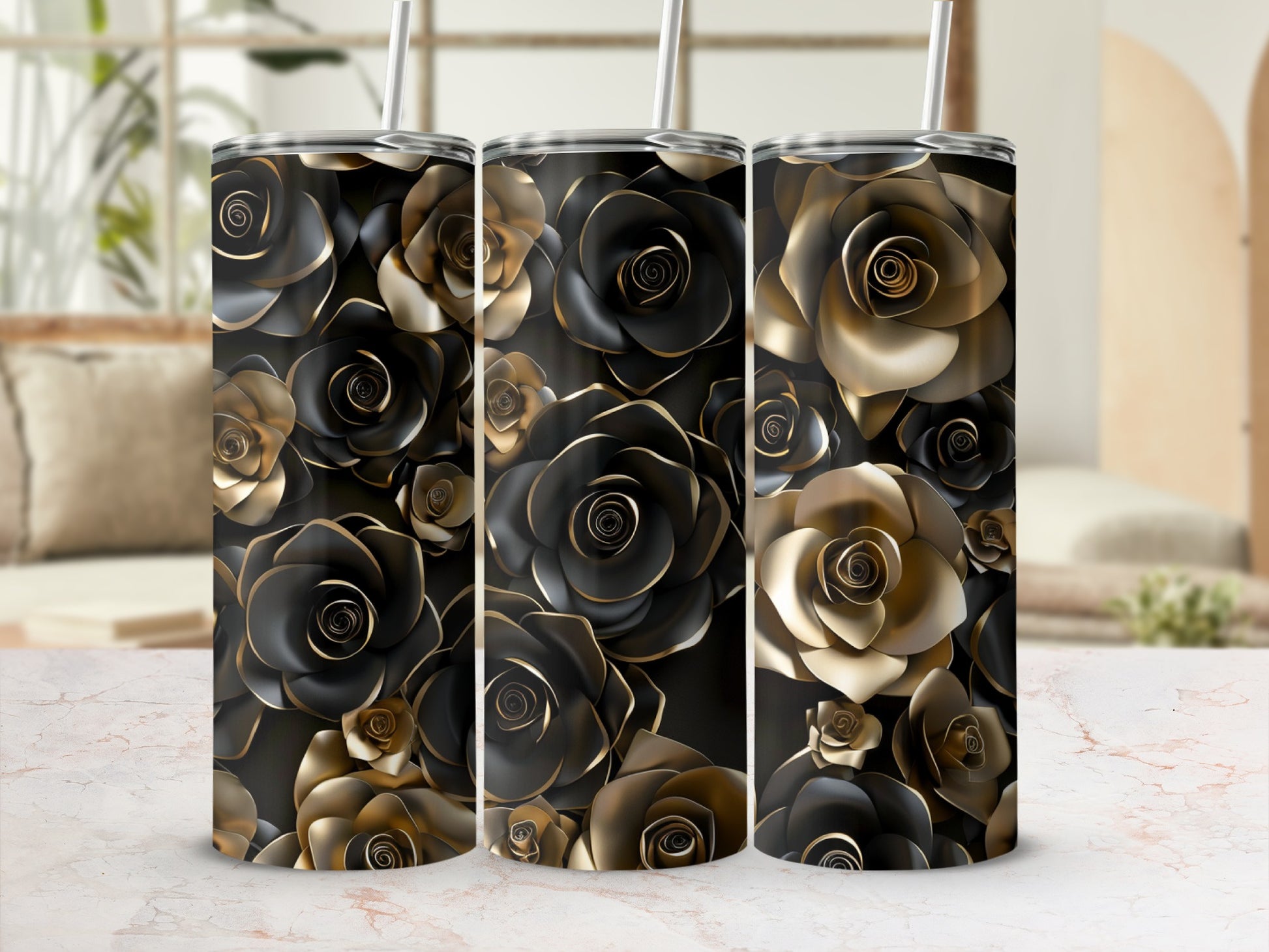 Three metallic gold and black rose patterned tumblers with straws.