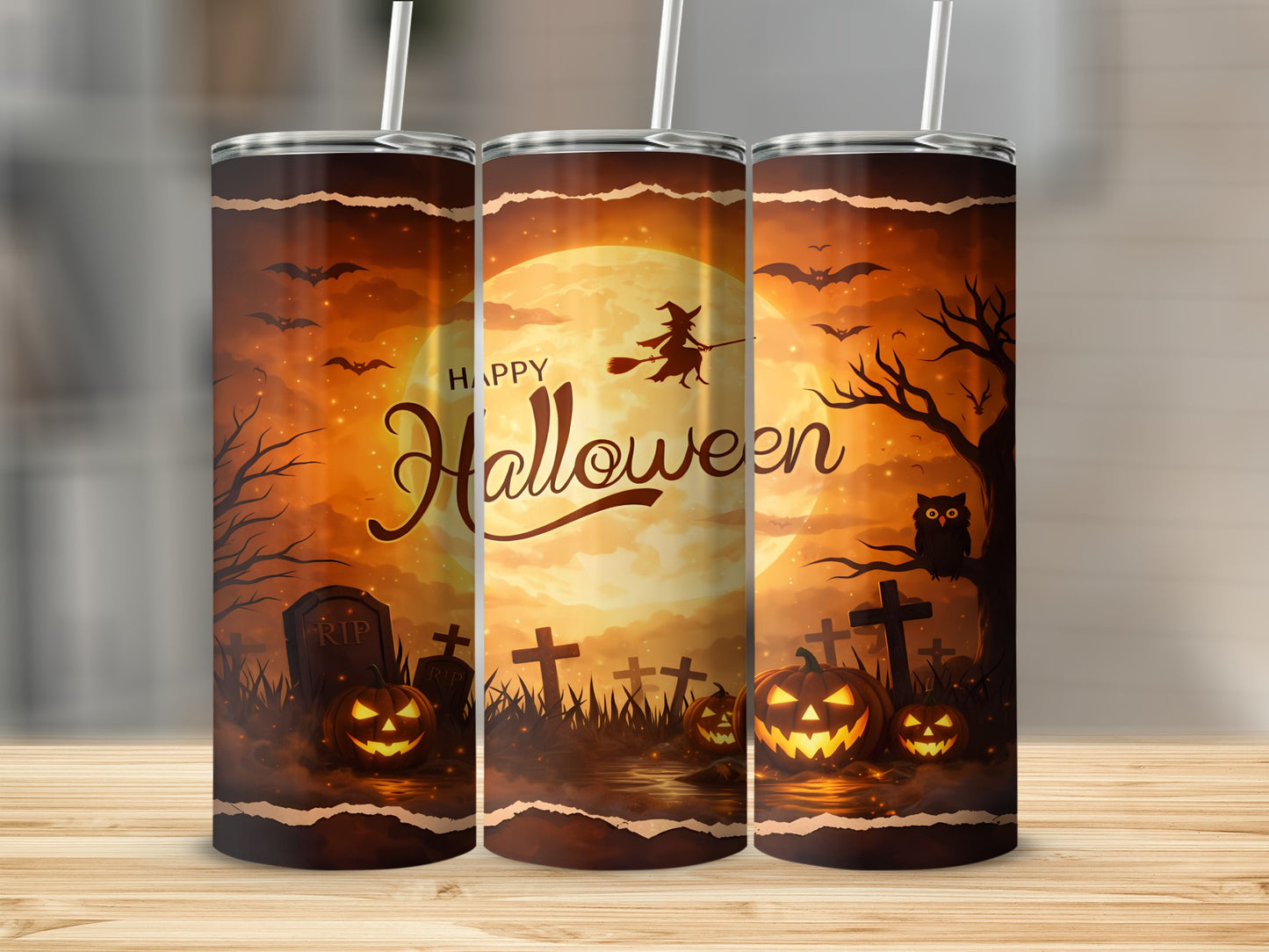 Three tumblers with Halloween theme art featuring pumpkins, bats, and a witch on a broom.