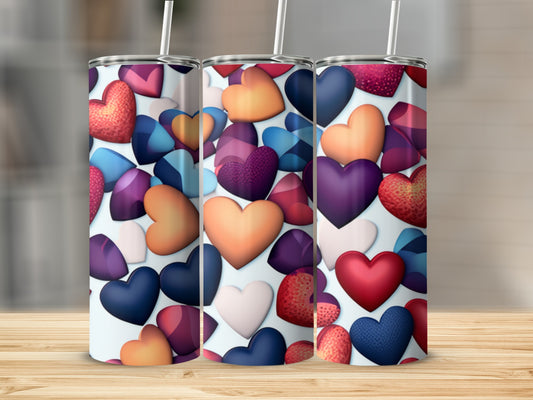 Three tumblers with a repeating pattern of colorful hearts.