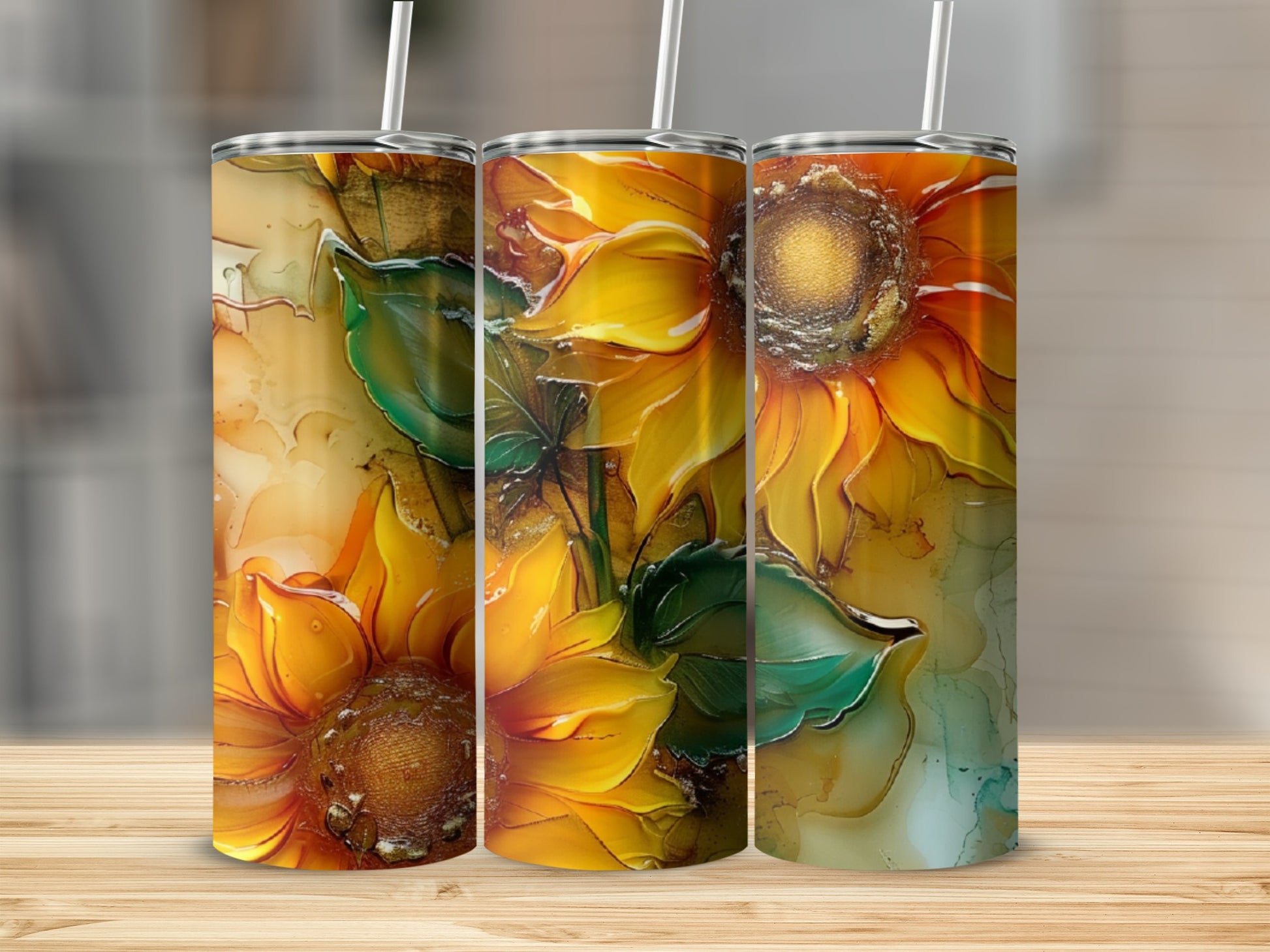Three tumblers with a vibrant, abstract sunflower design and green leaves.