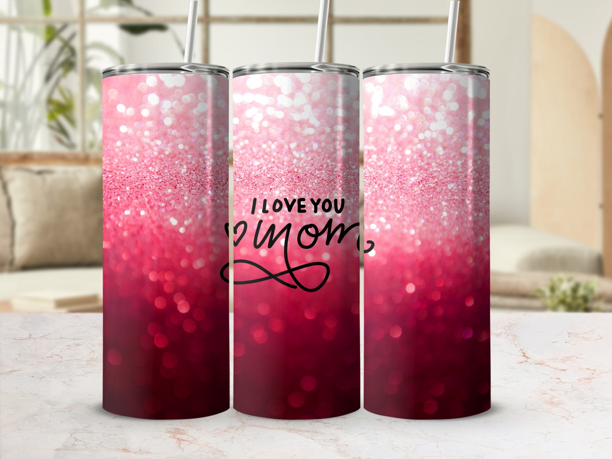 Pink glitter tumbler with "I Love You Mom" text on a blurred background.