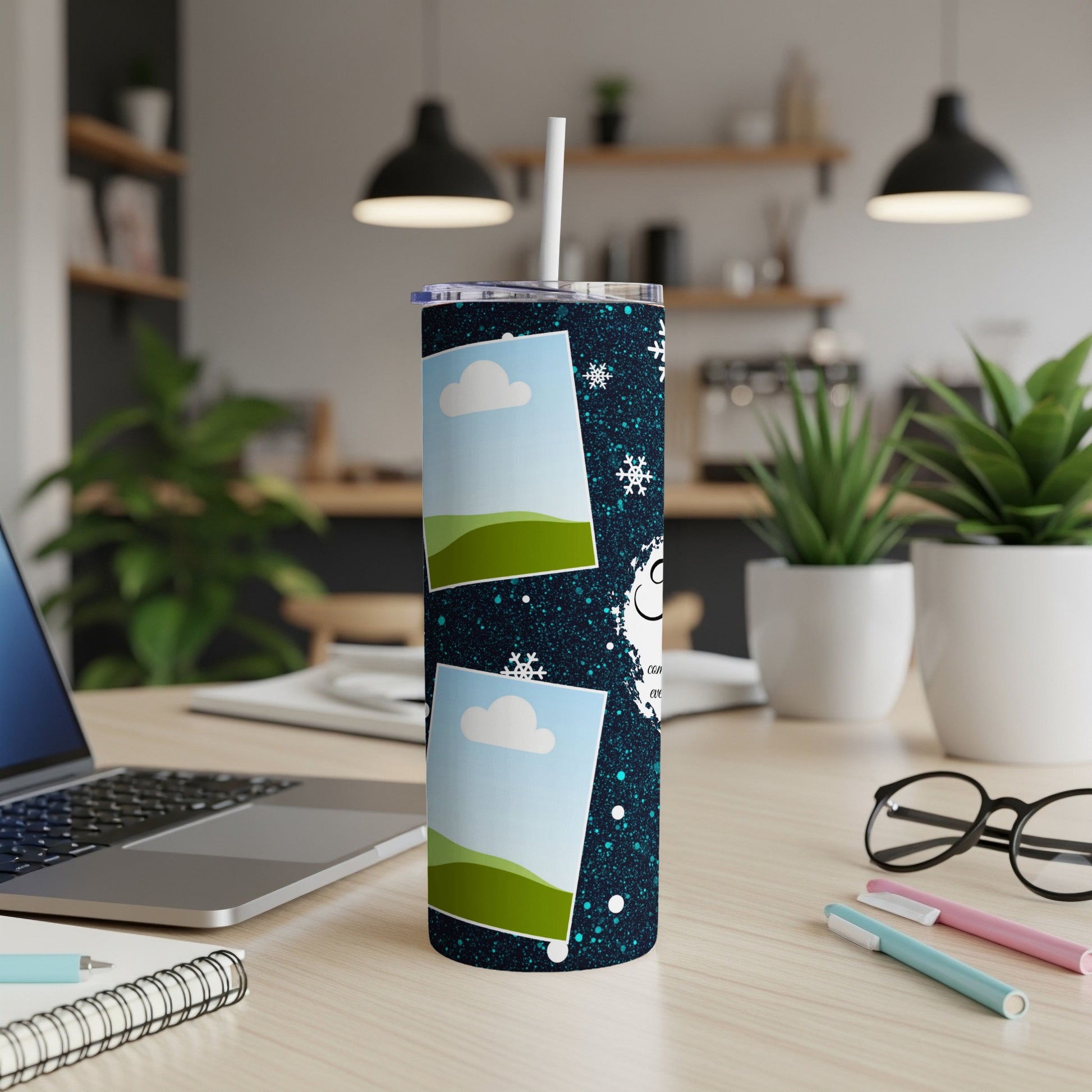 Tumbler with blue speckled design, photos, snowflakes, and text.