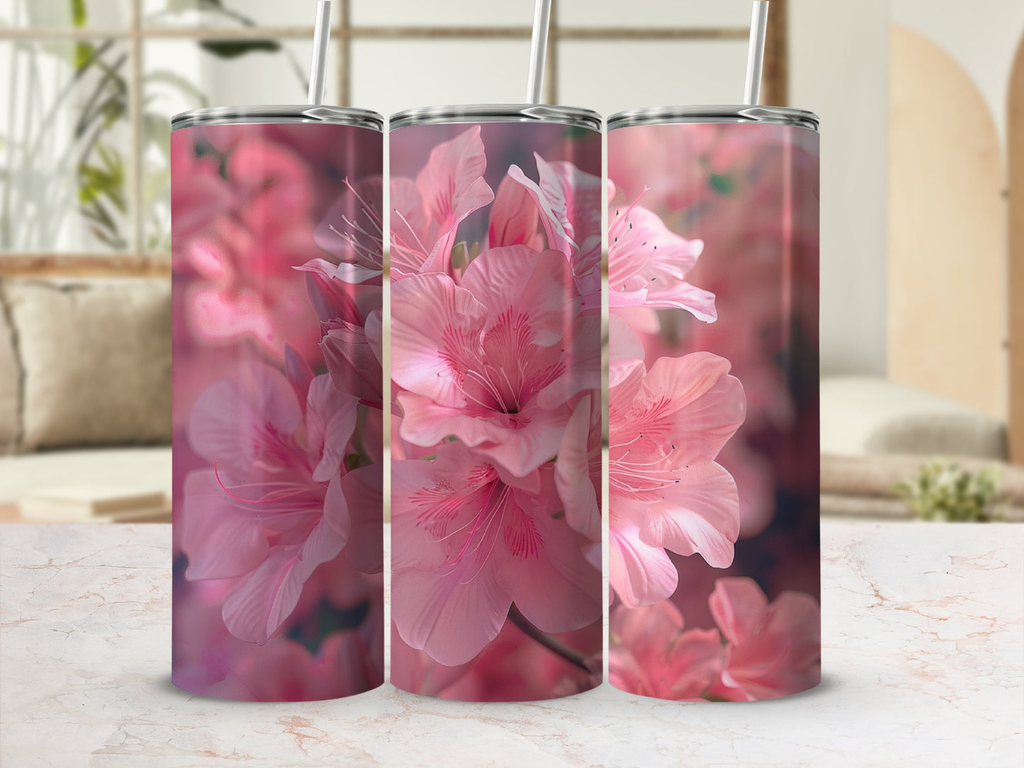 Pink azalea flowers on a tumbler with straw in a bright room.