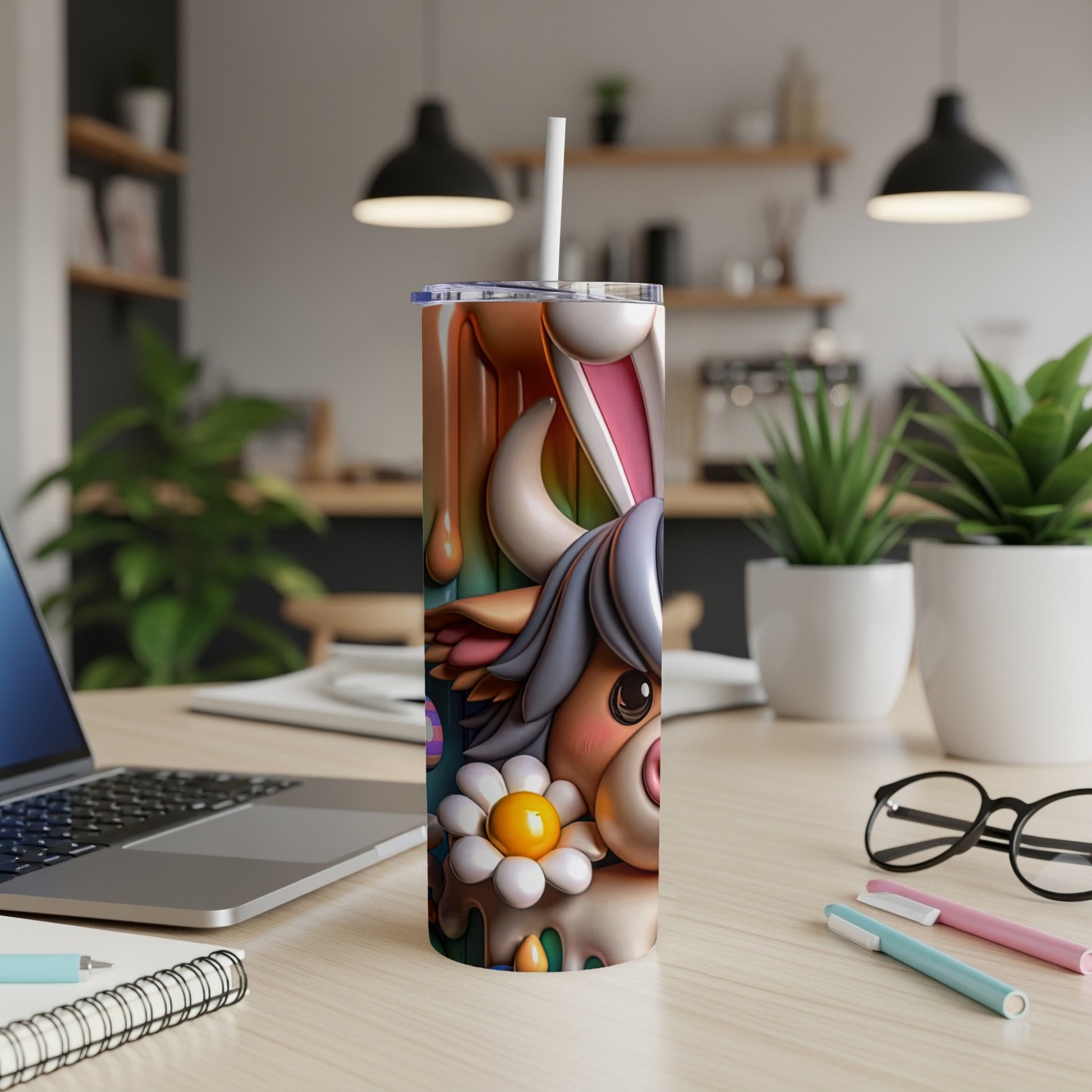 Easter bunny cow tumbler with straw on a desk.