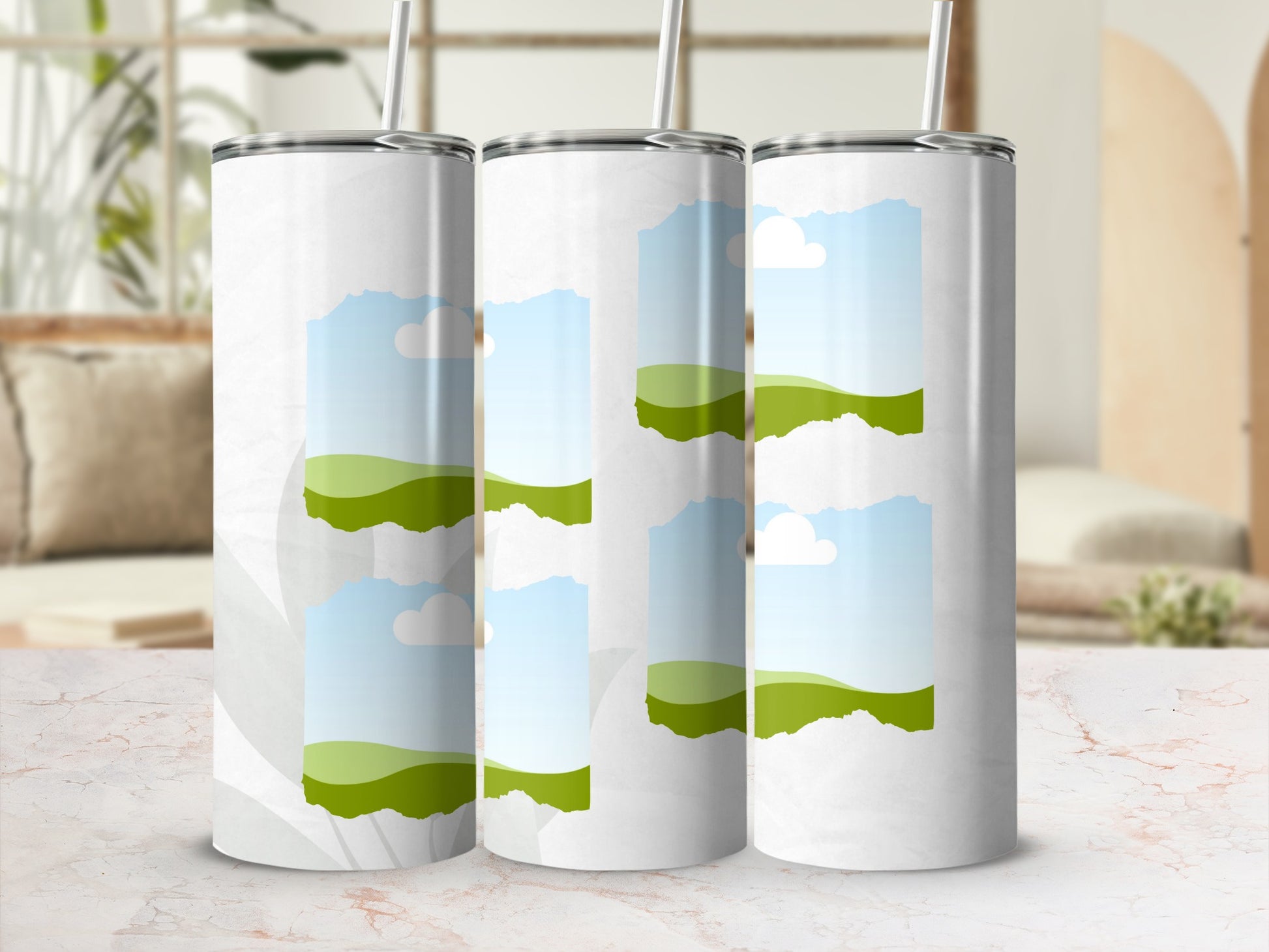 Three white tumblers with a sky and rolling green hills graphic design.